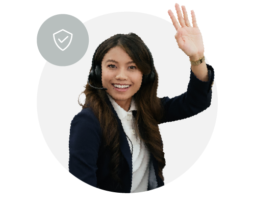 A woman wearing a contact center headset and business attire, smiling and waving.
.