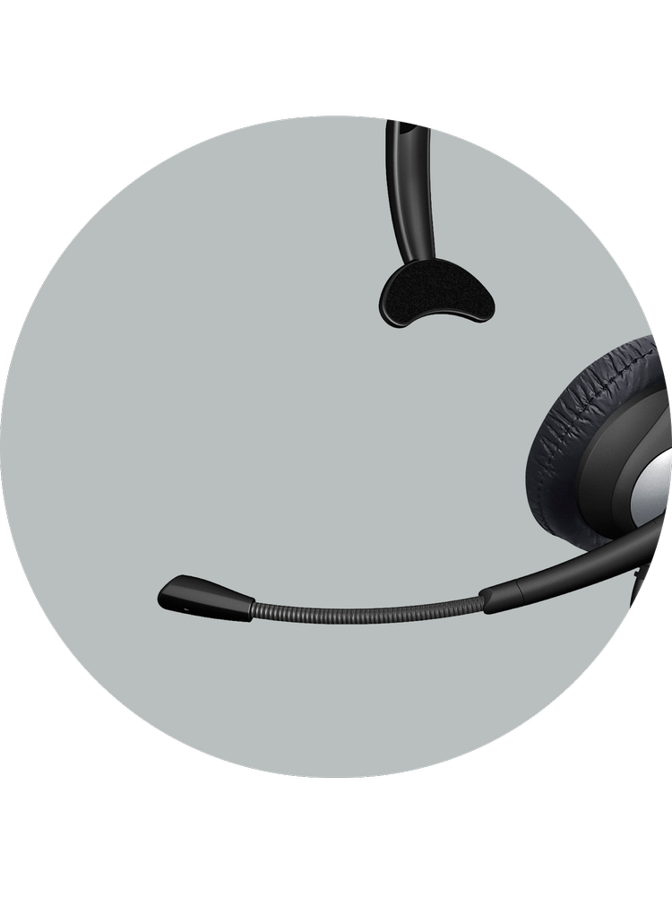 Close-up of the AC-104 mono headset's single earcup and unidirectional boom microphone, designed to minimize surrounding background noise