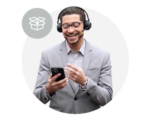 A man in a gray suit and glasses smiling while looking at his phone, wearing a wireless professional headset, with a chat icon in a speech bubble background.