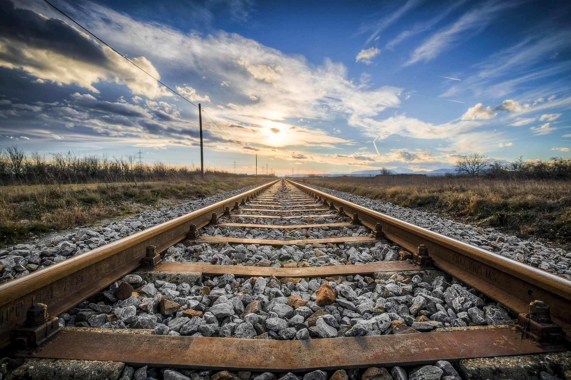 railways tracks under a sunset sky as a metaphor for a hopeful future