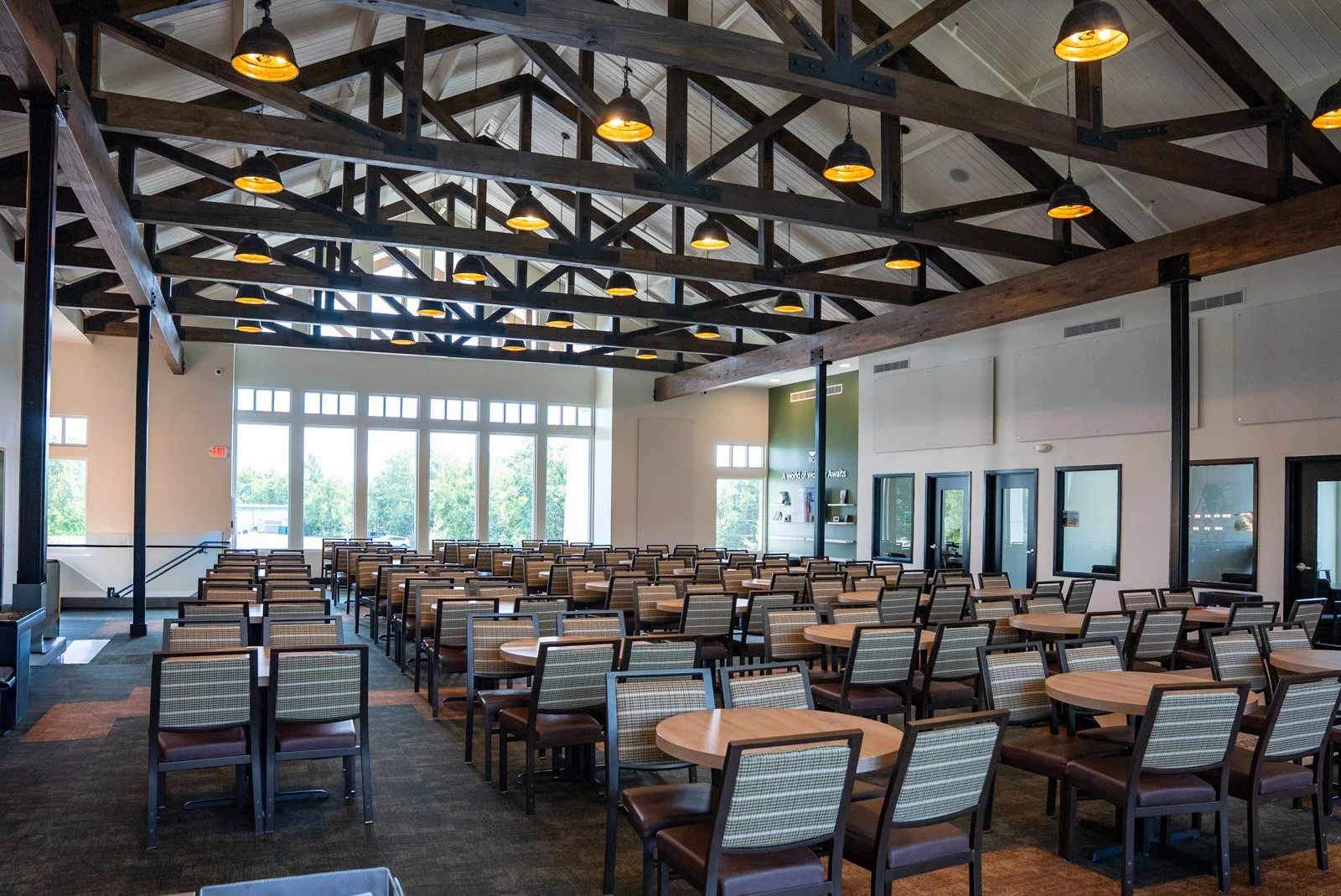 Exposed timber trusses and abundant natural light define the upstairs space.