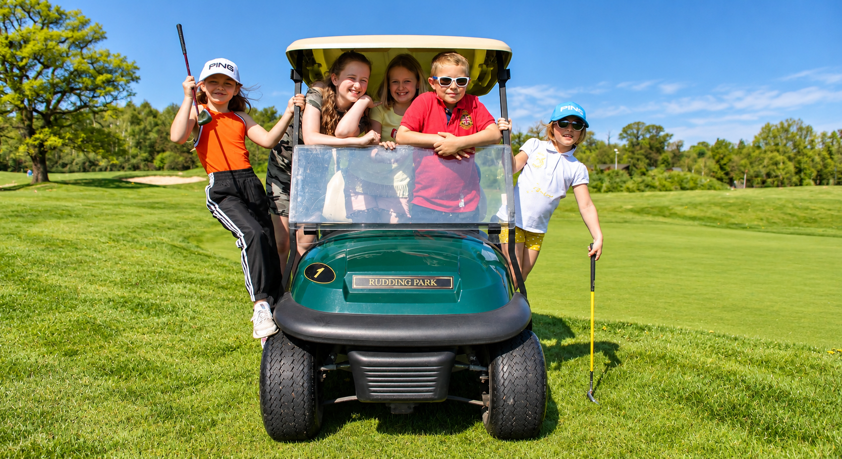 Junior golfers in golf buggy at Rudding Park, Harrogate