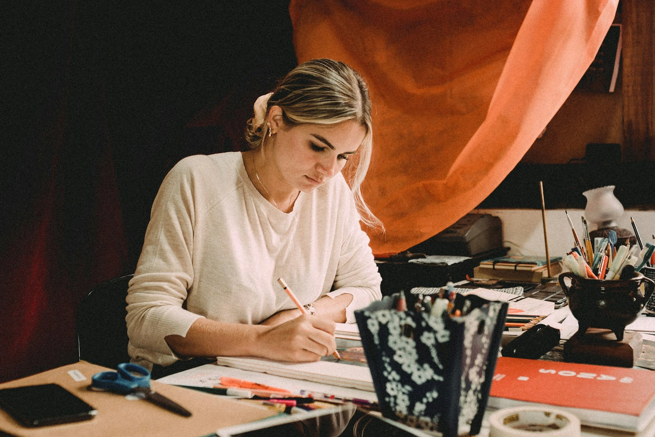 Woman drawing alone at her desk
