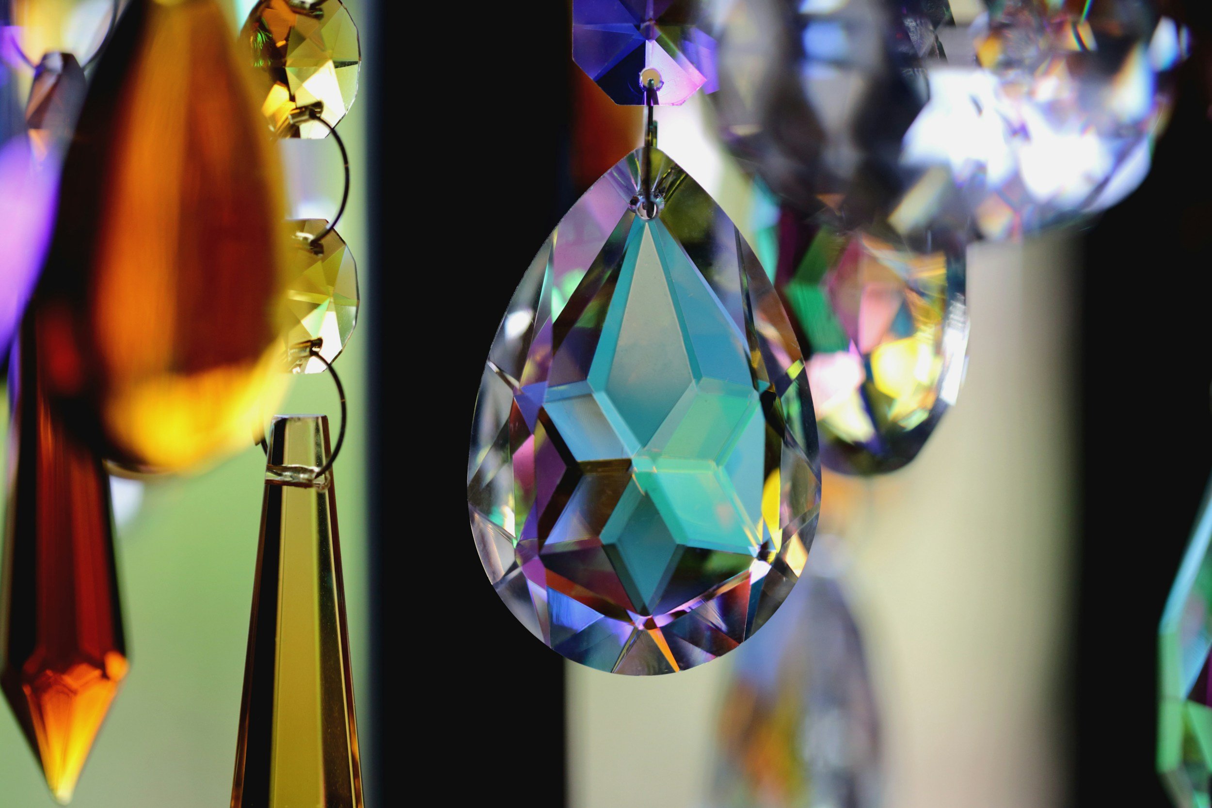 glass beads hanging by a window, with a prism effect