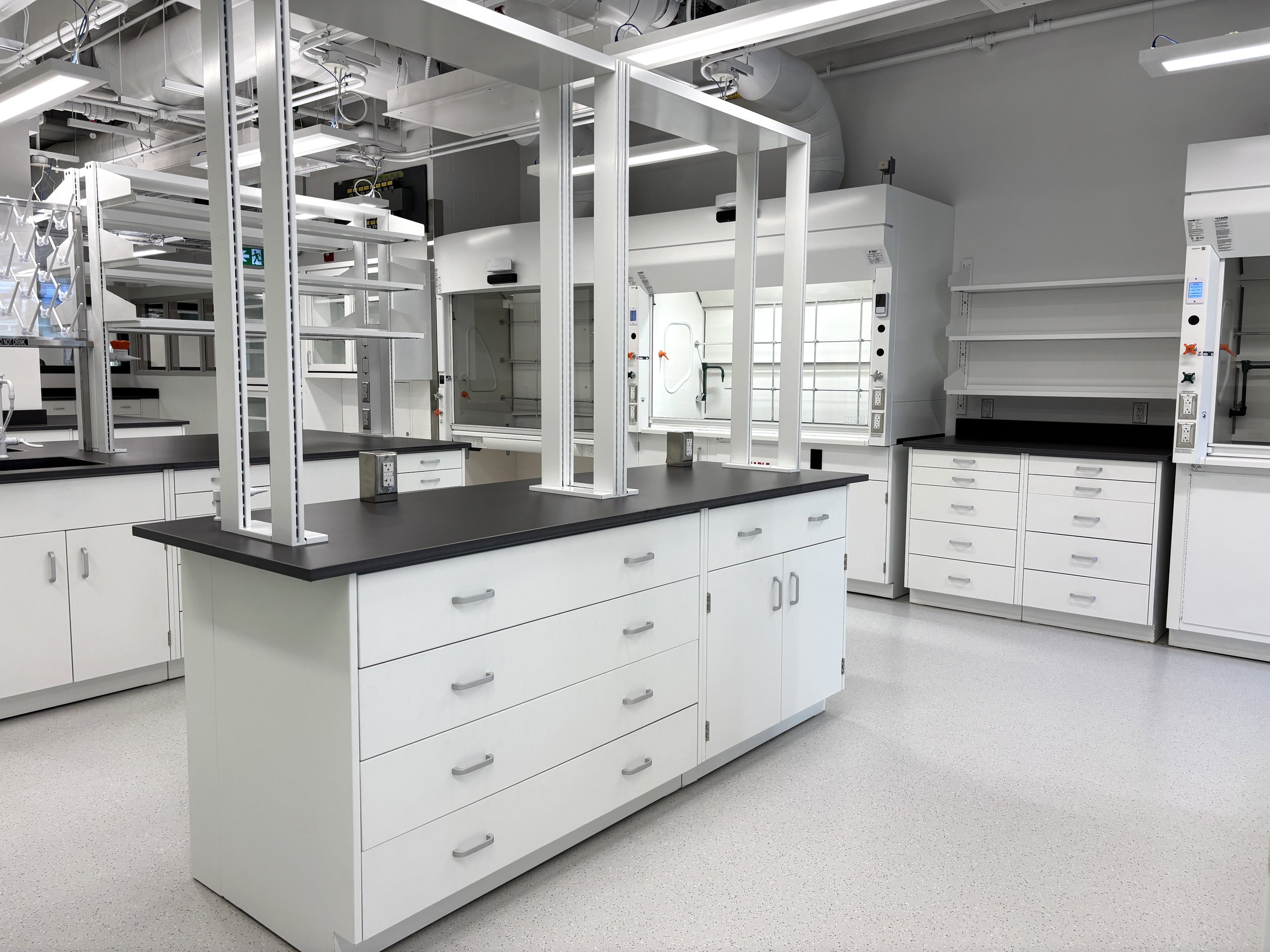 Painted steel cabinets with benchtop uprights, in a lab