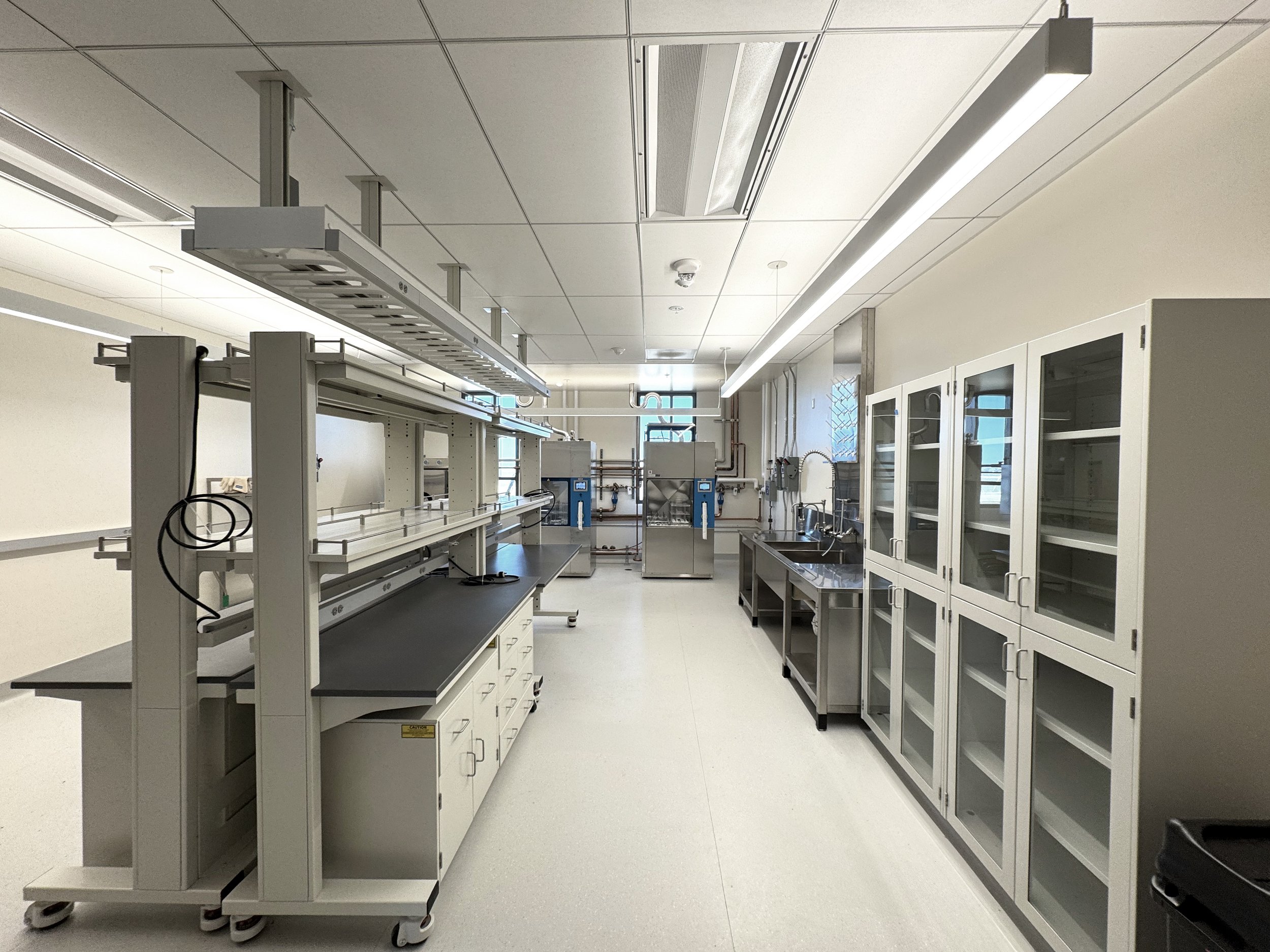 Mobile Heavy duty workstations, floor cabinets, stainless steel scullery sink, in a lab