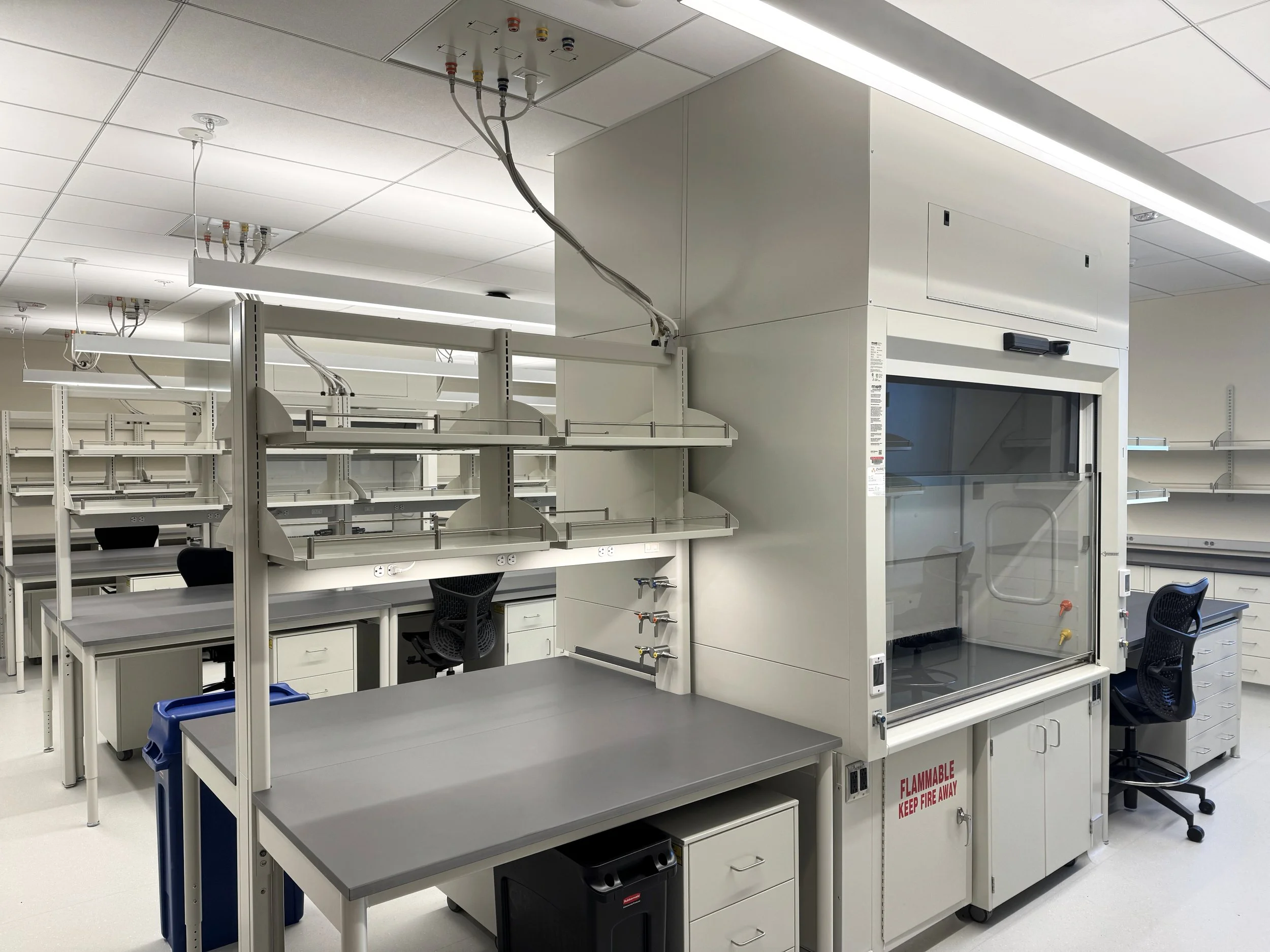 Optima benches with steel casework below, and fume hoods, in a lab