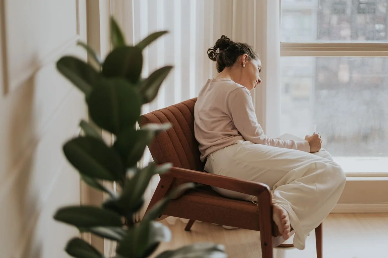 contemplative-woman-relaxing-by-window