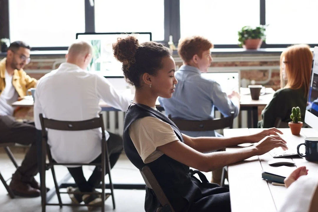woman-in-white-and-black-top-using-computer