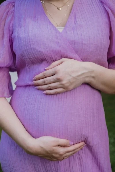 Pregnant woman with hands on belly