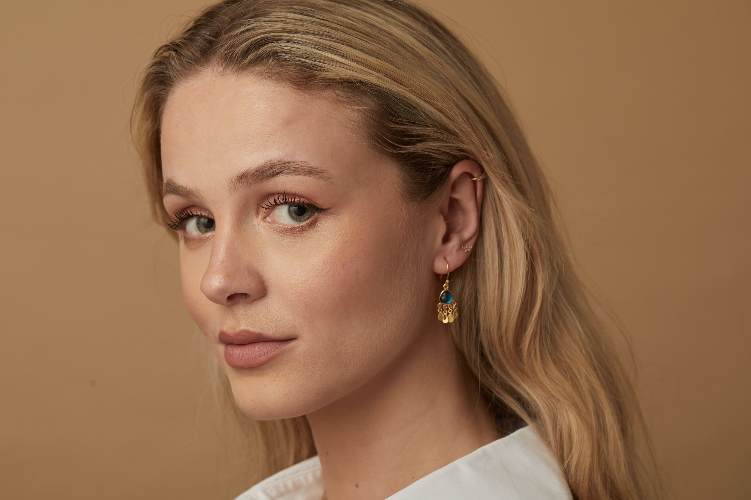 Blue Topaz Er with charms on model.jpg