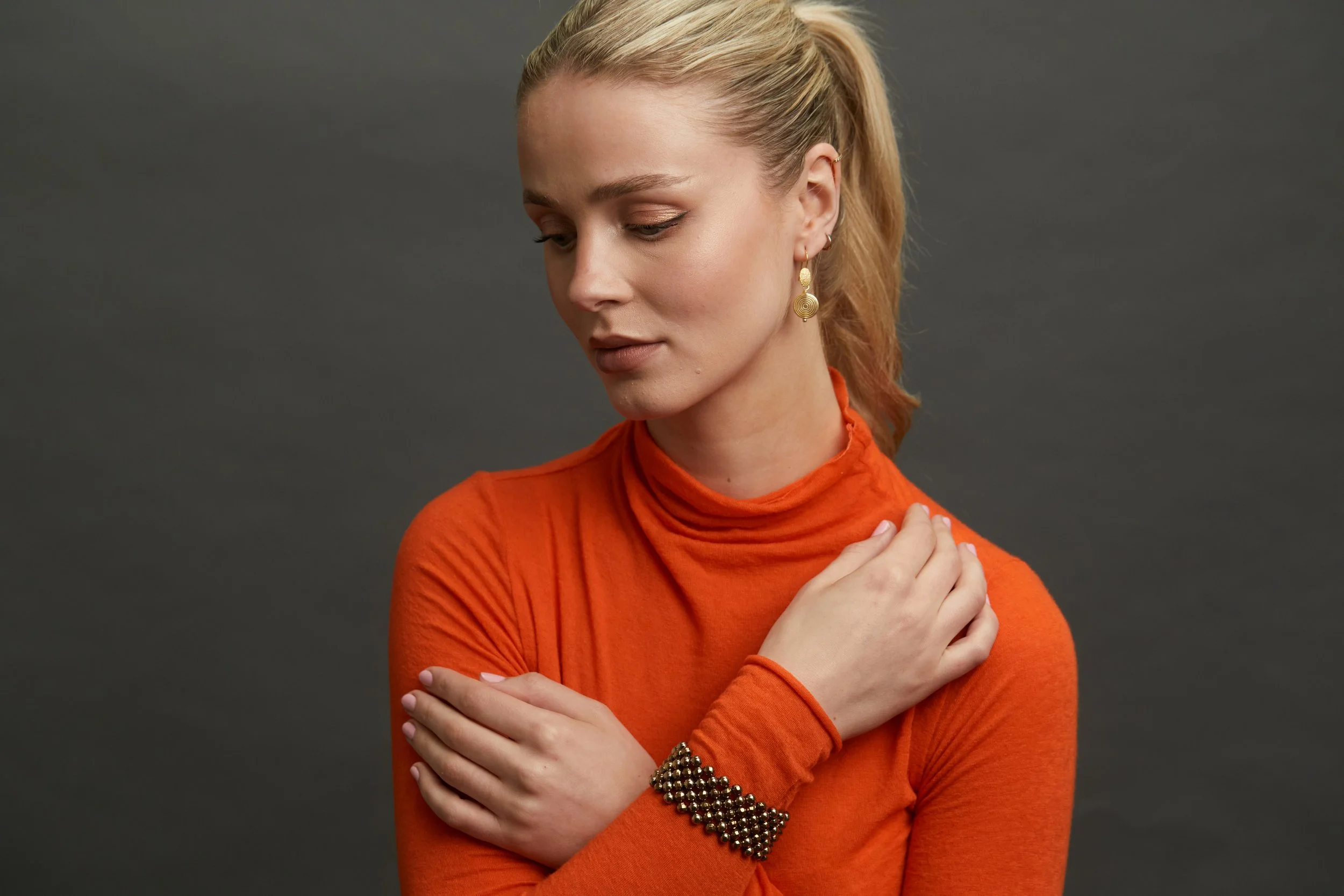 Gold Disc Drop Er and Gold Pyrite Cuff on model.jpg