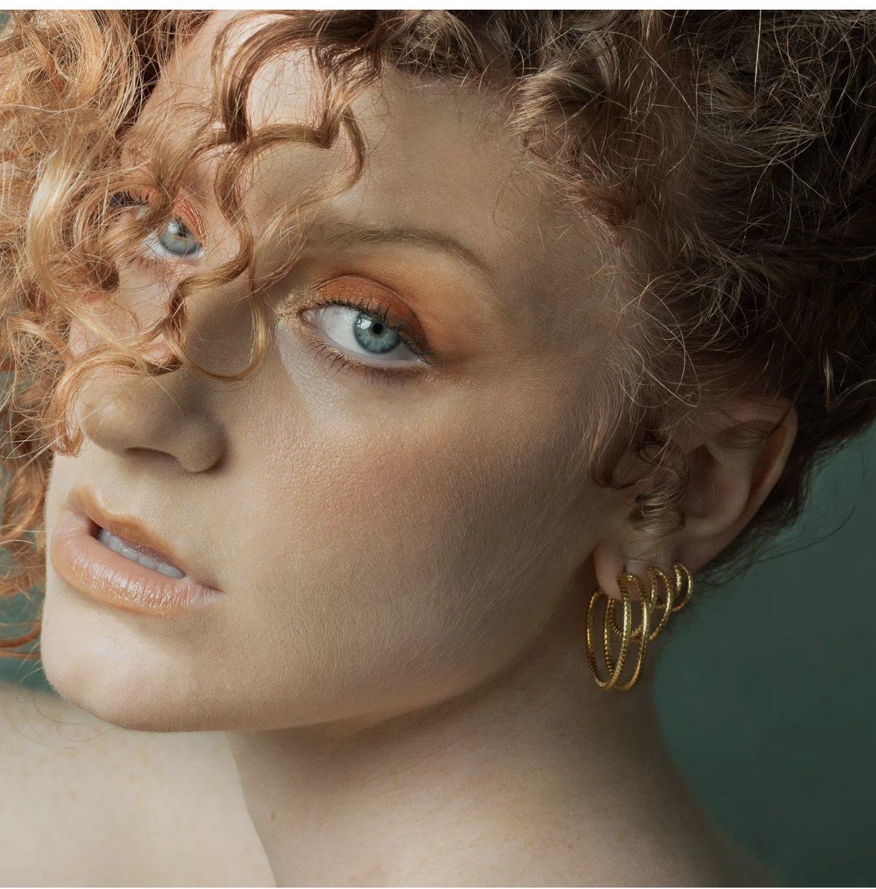 Serpentine Medium Hoops In Gold on model.png