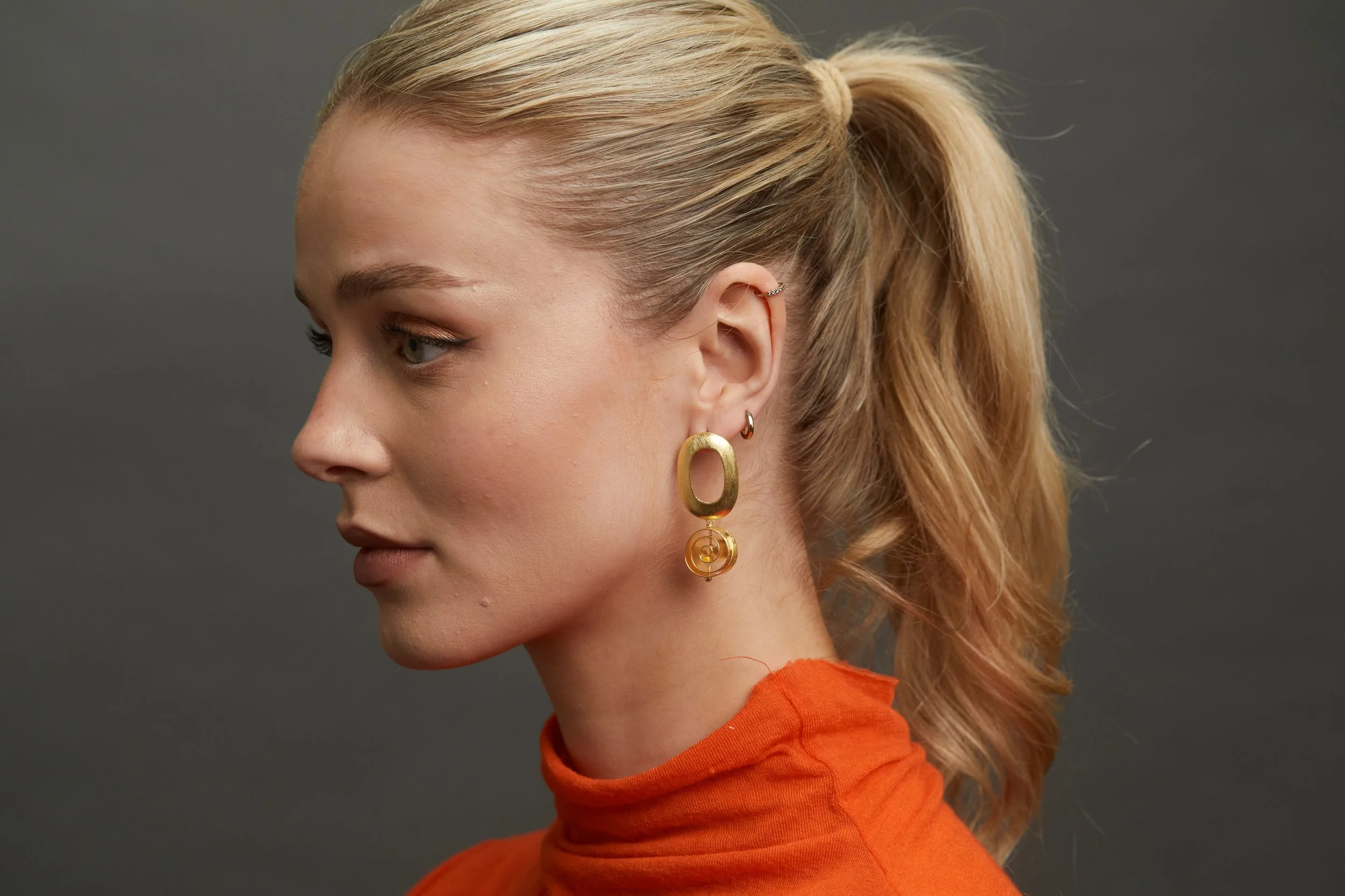 Gold Swirl Er on model close up.jpg
