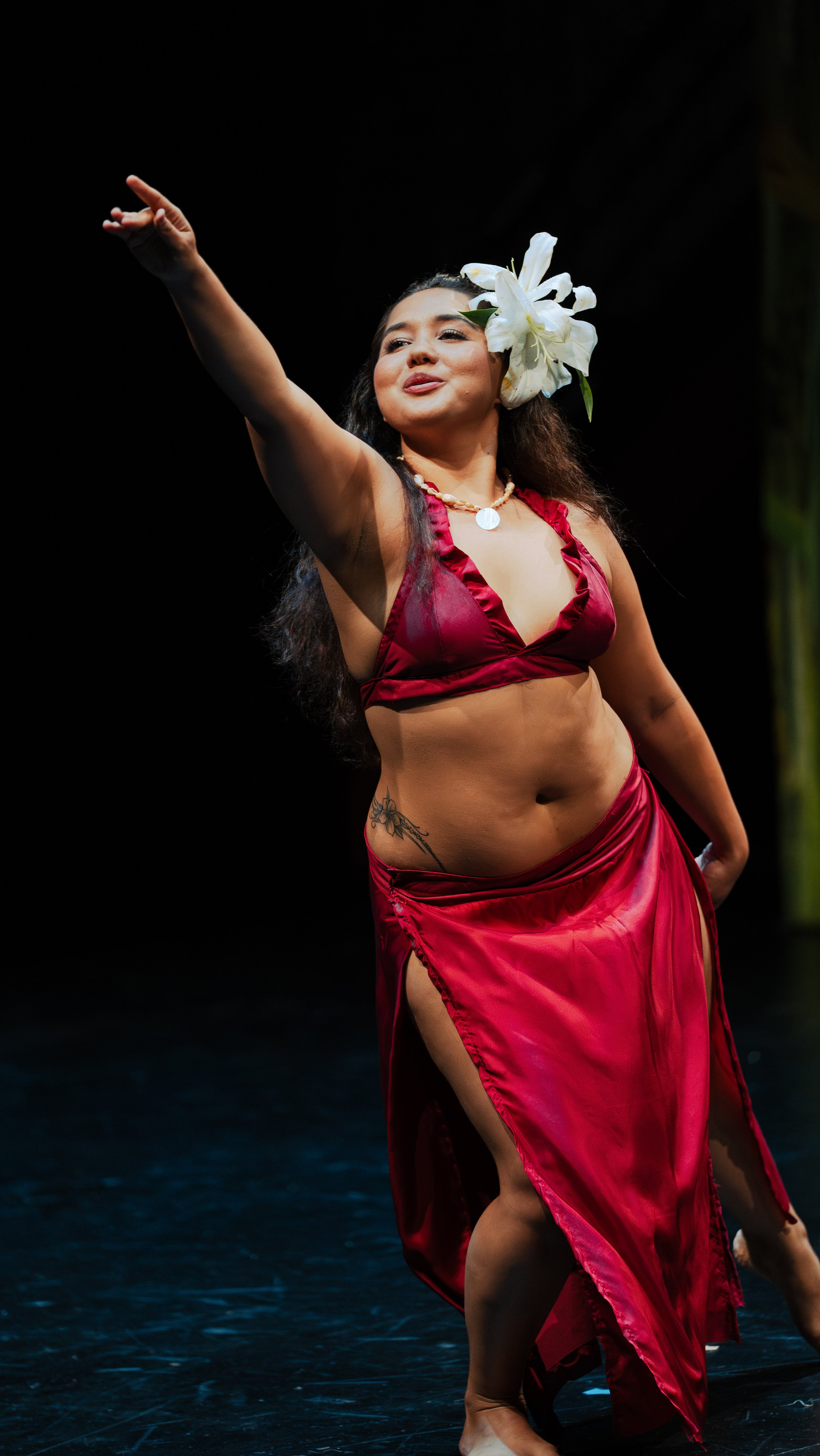 Woman performing a traditional dance in a red outfit