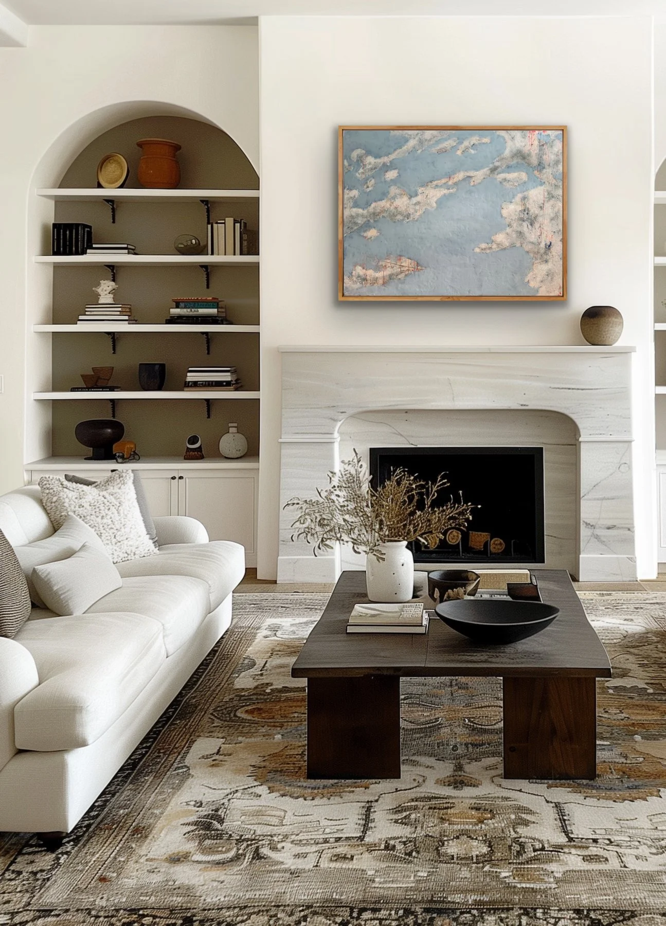 Cloud Drift Atlas encaustic abstract landscape painting displayed above a white fireplace in a bright living room with neutral furniture, built-in shelves, and modern organic decor.