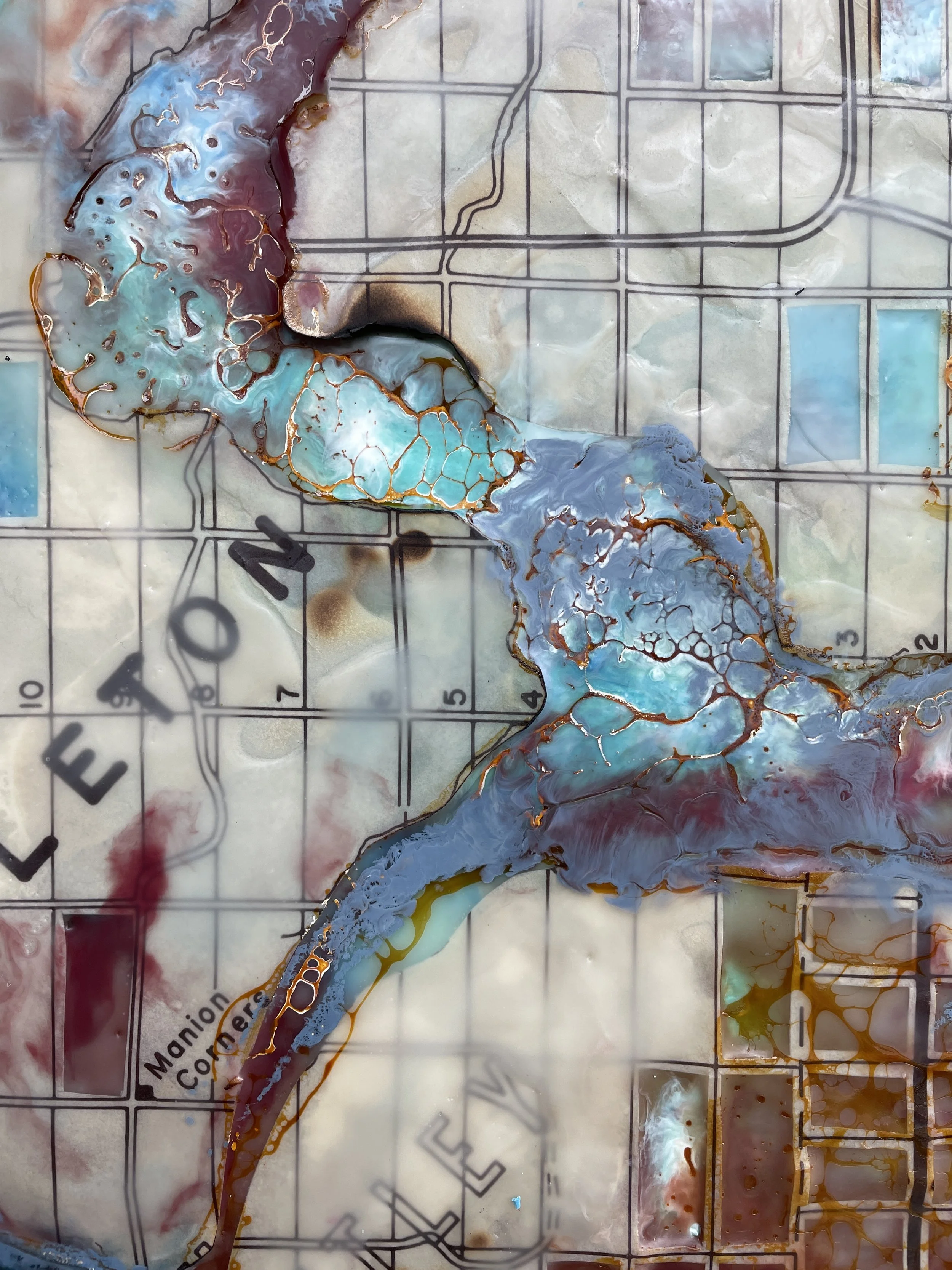 Detail of River Logic showing encaustic texture layered blue pigment natural river curves and antique cartography.