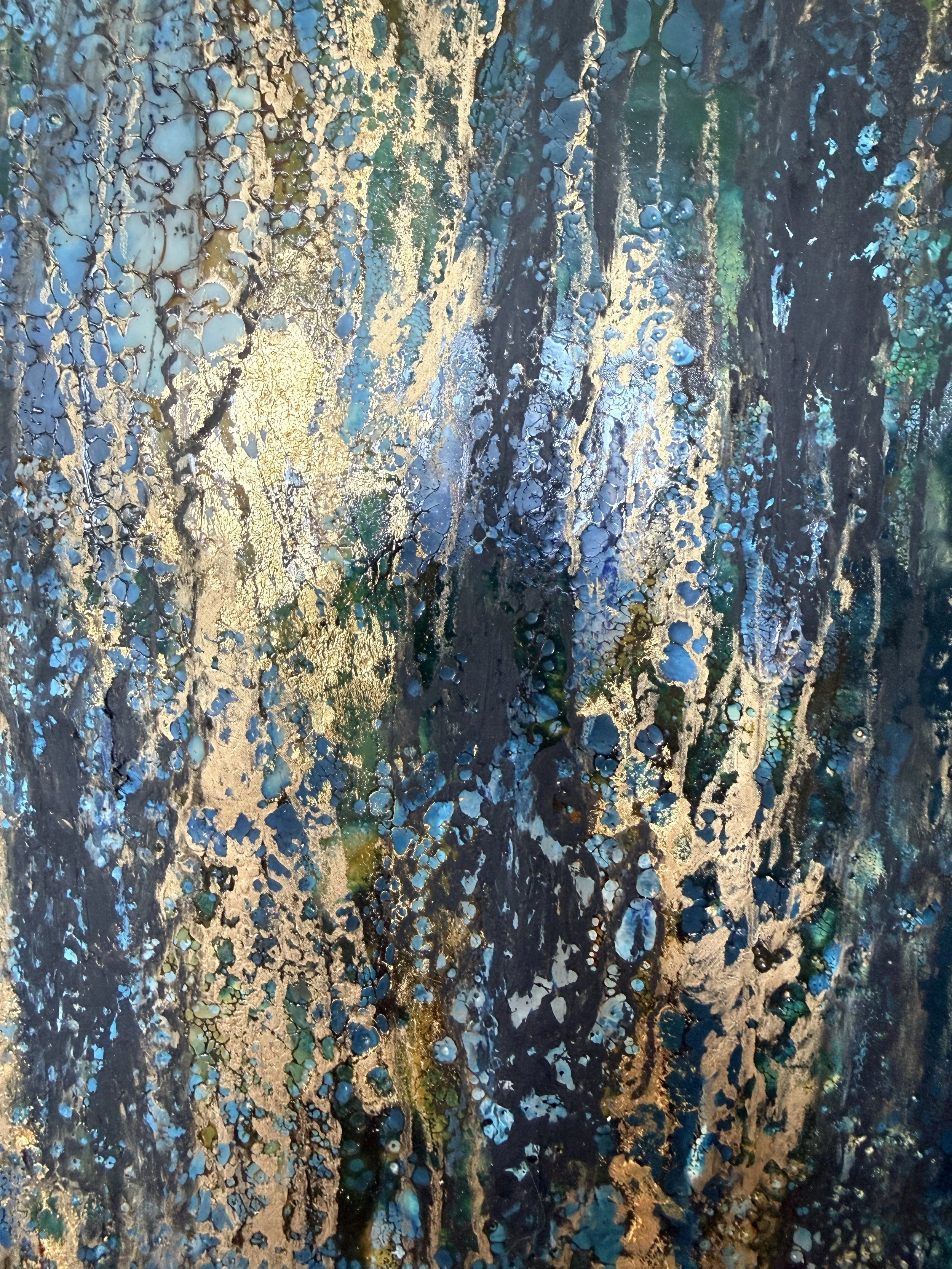 Close-up detail of Nocturne in Gold original encaustic painting, showing layered beeswax, shellac burn, gold leaf, blue pigment, texture, and luminous abstract surface.