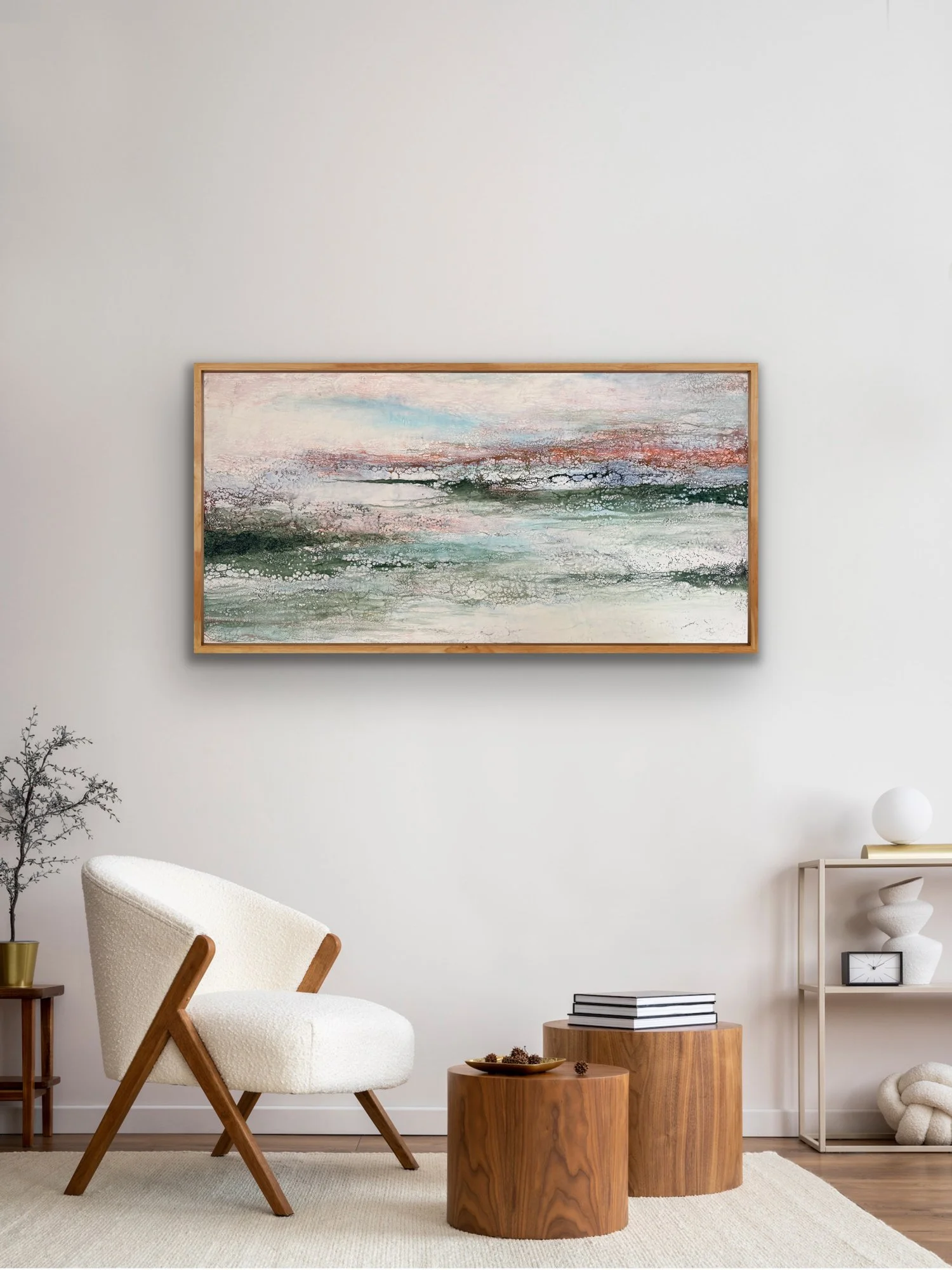 Lowland Light, a large original encaustic abstract landscape painting by Seattle artist Robin Moore, shown in a modern interior above a cream boucle chair with warm wood cabinetry.