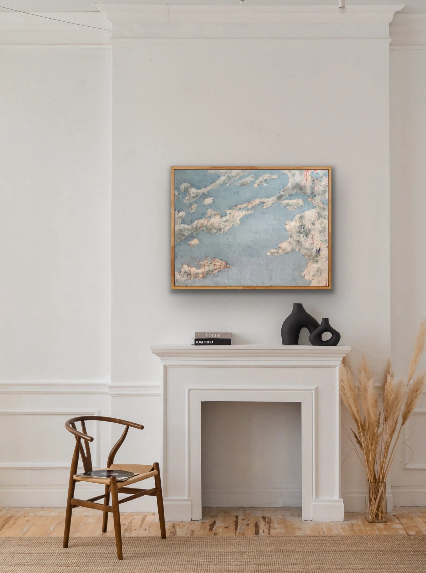 Cloud Drift Atlas original encaustic artwork displayed above a white fireplace with natural oak frame, soft blue abstract landscape, warm neutrals, and modern minimalist styling.