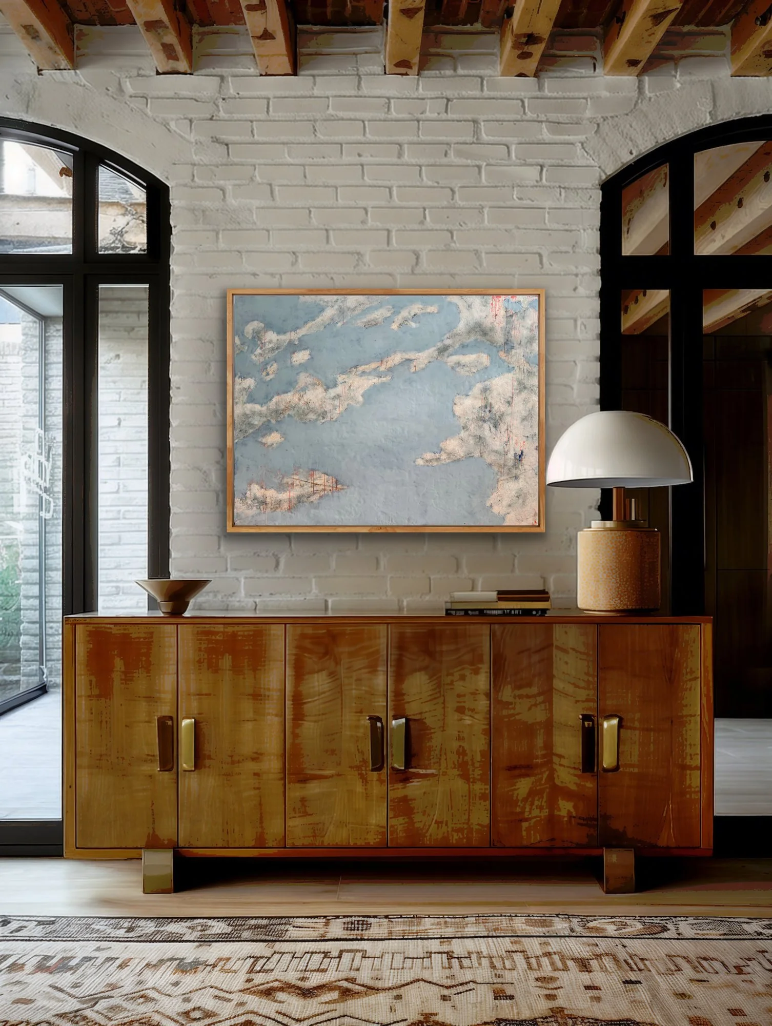 Cloud Drift Atlas encaustic abstract landscape painting displayed above a white fireplace in a bright living room with neutral furniture, built-in shelves, and modern organic decor.