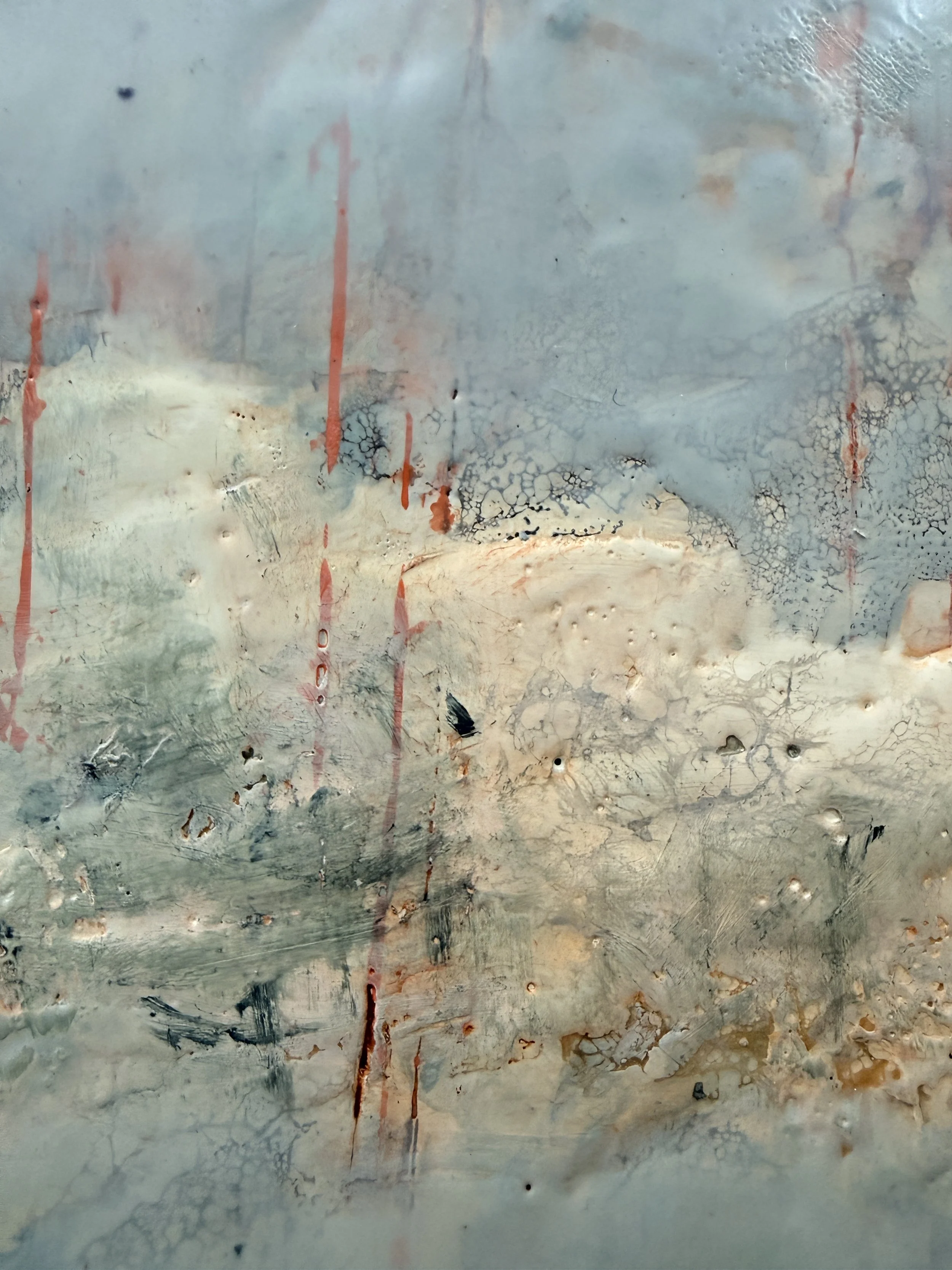 Close-up detail of Cloud Drift Atlas with airy blue and white encaustic layers, rust-red drips, shellac burn texture, and expressive abstract landscape markings.