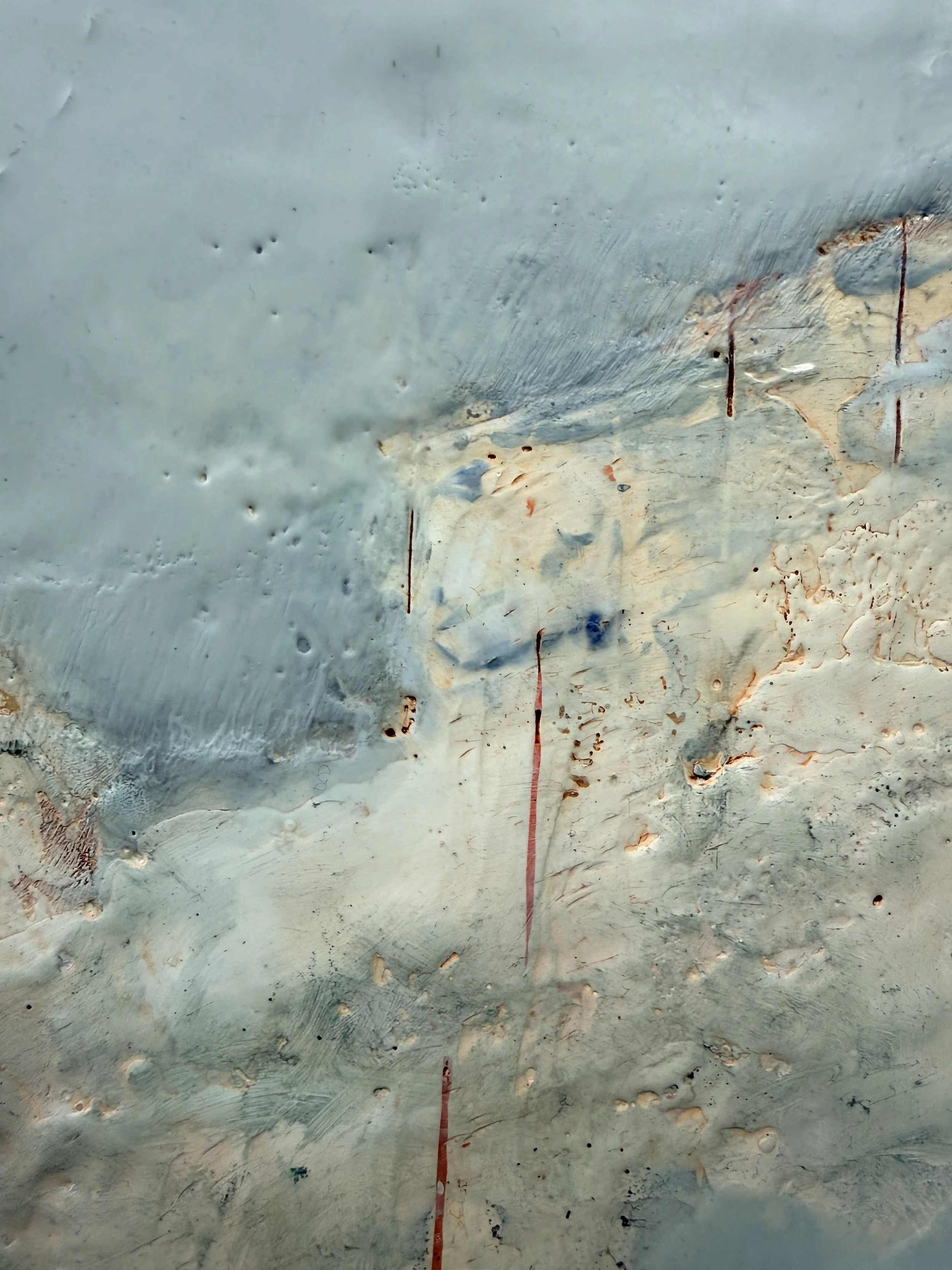Detail of Cloud Drift Atlas showing pale blue encaustic surface, soft cloud-like forms, natural texture, rust-red line work, and layered beeswax and pigment.