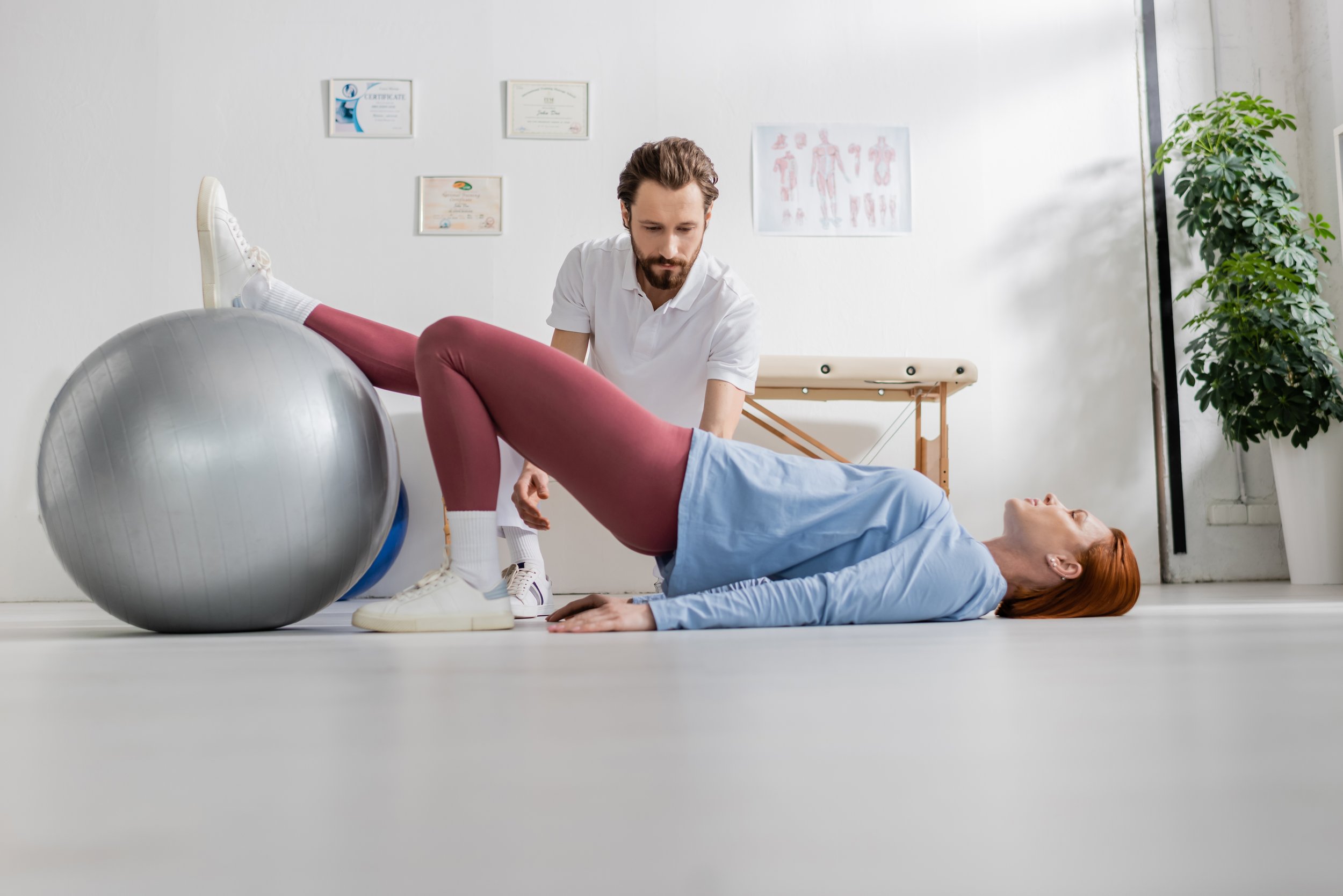 Physiotherapist consulting with a woman about pelvic pain at an Islington clinic