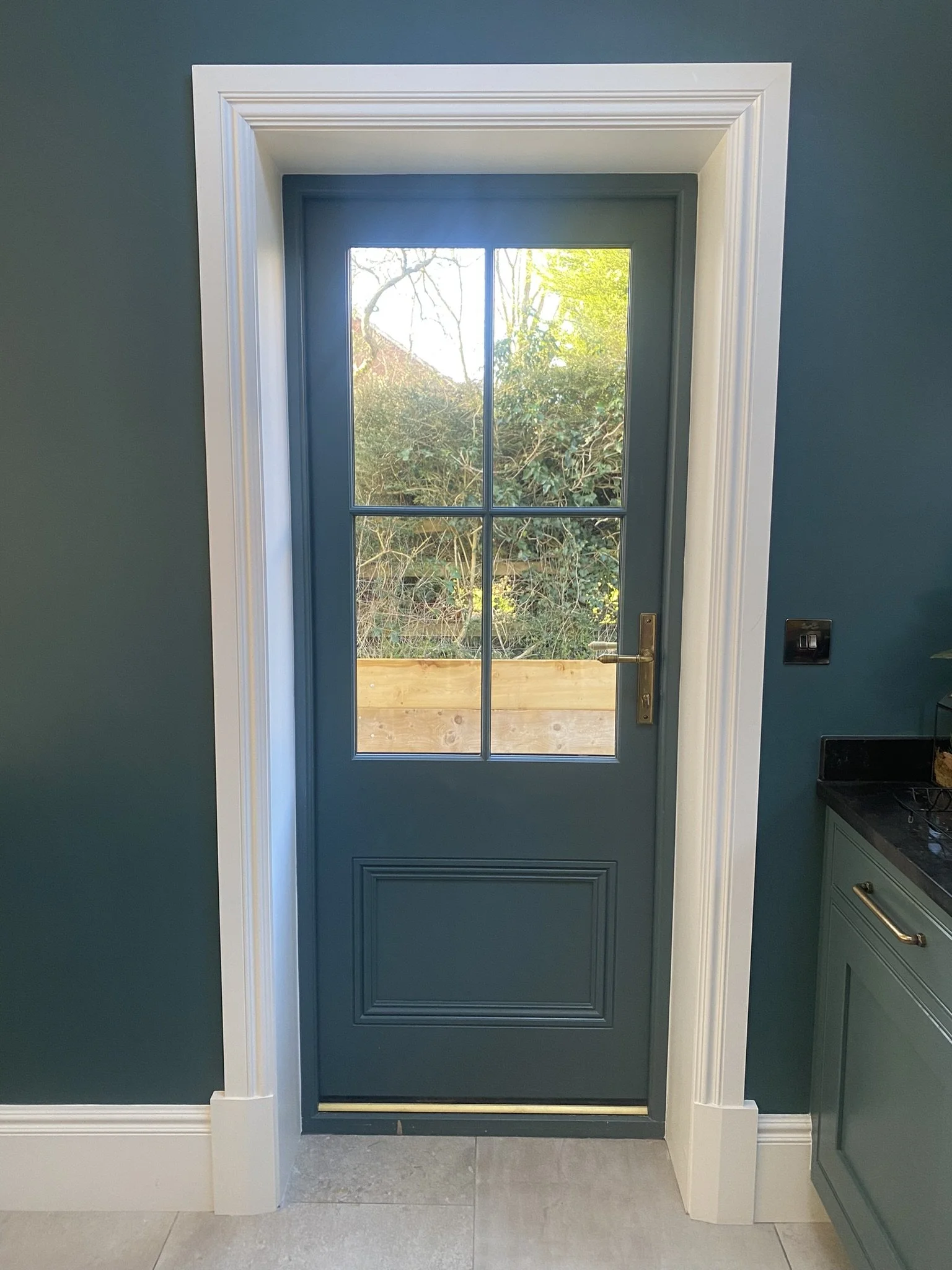 Bespoke high performance softwood door and frame, with reeded aged brass hardware from Anvil, with Georgian glazing bars fully finished in farrow & ball Inchyra blue. 