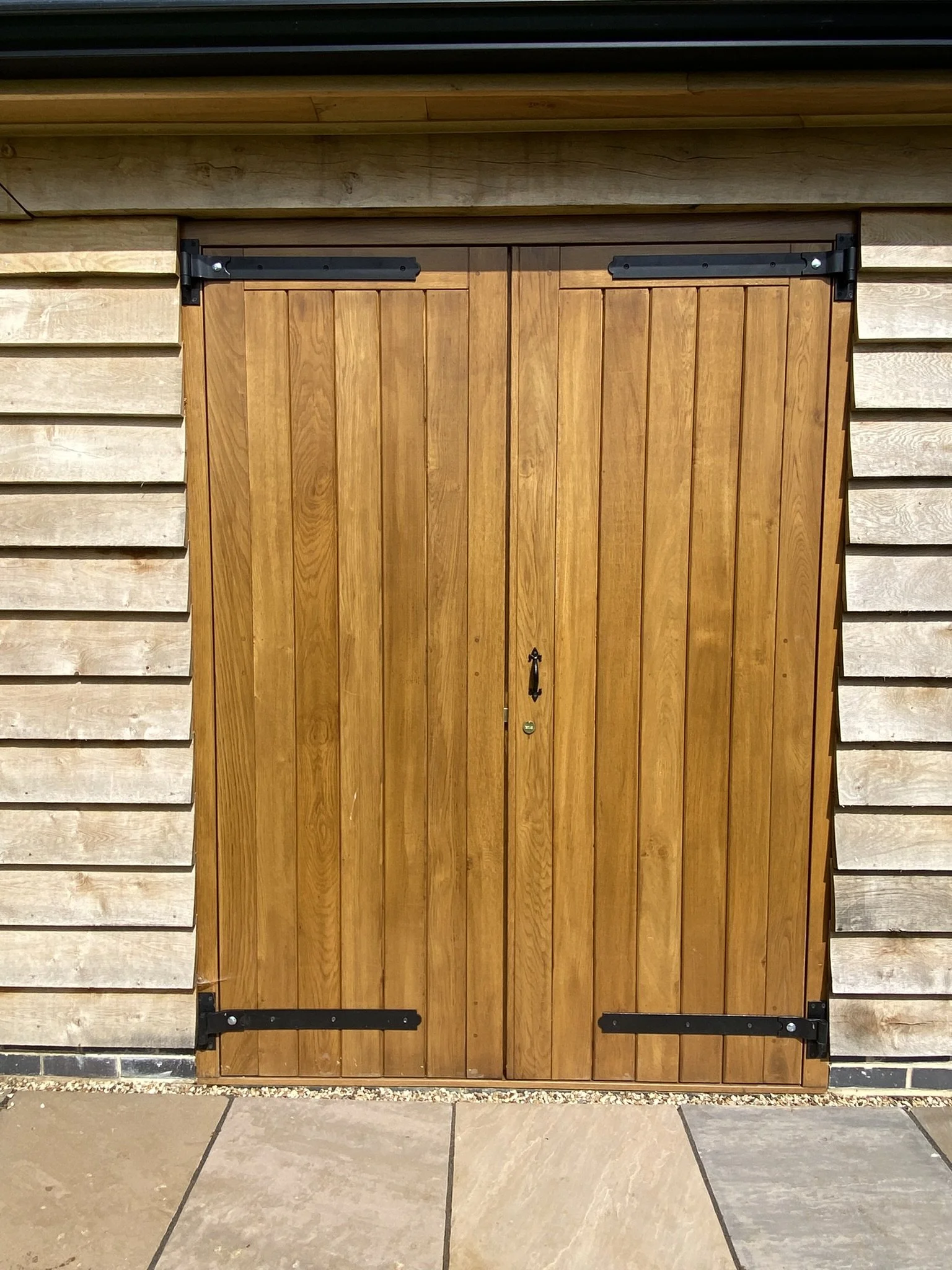 Oak garage doors with black hardware