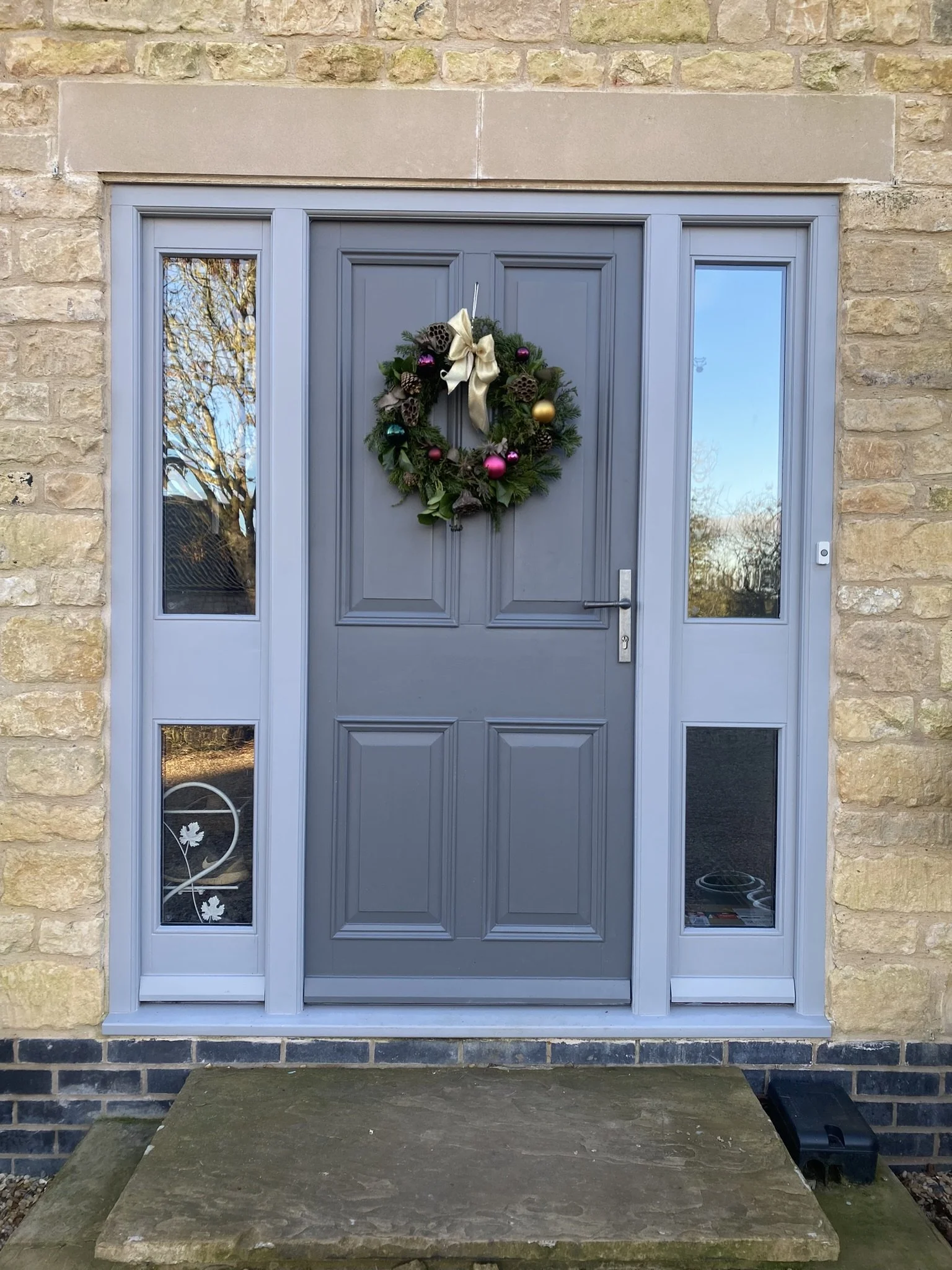 Bespoke high performance softwood Georgian paneled door and frame with twin weather seal &  sapele cill, glazed side lights and pewter hardware.