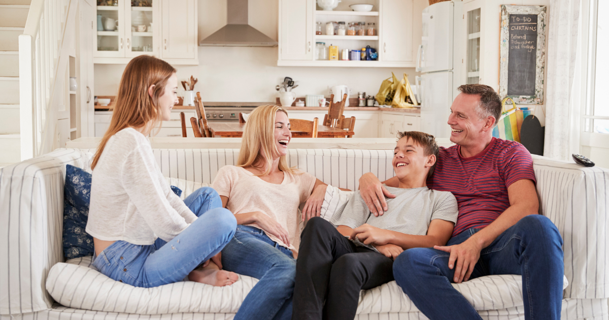 Happy Family laughing on the couch