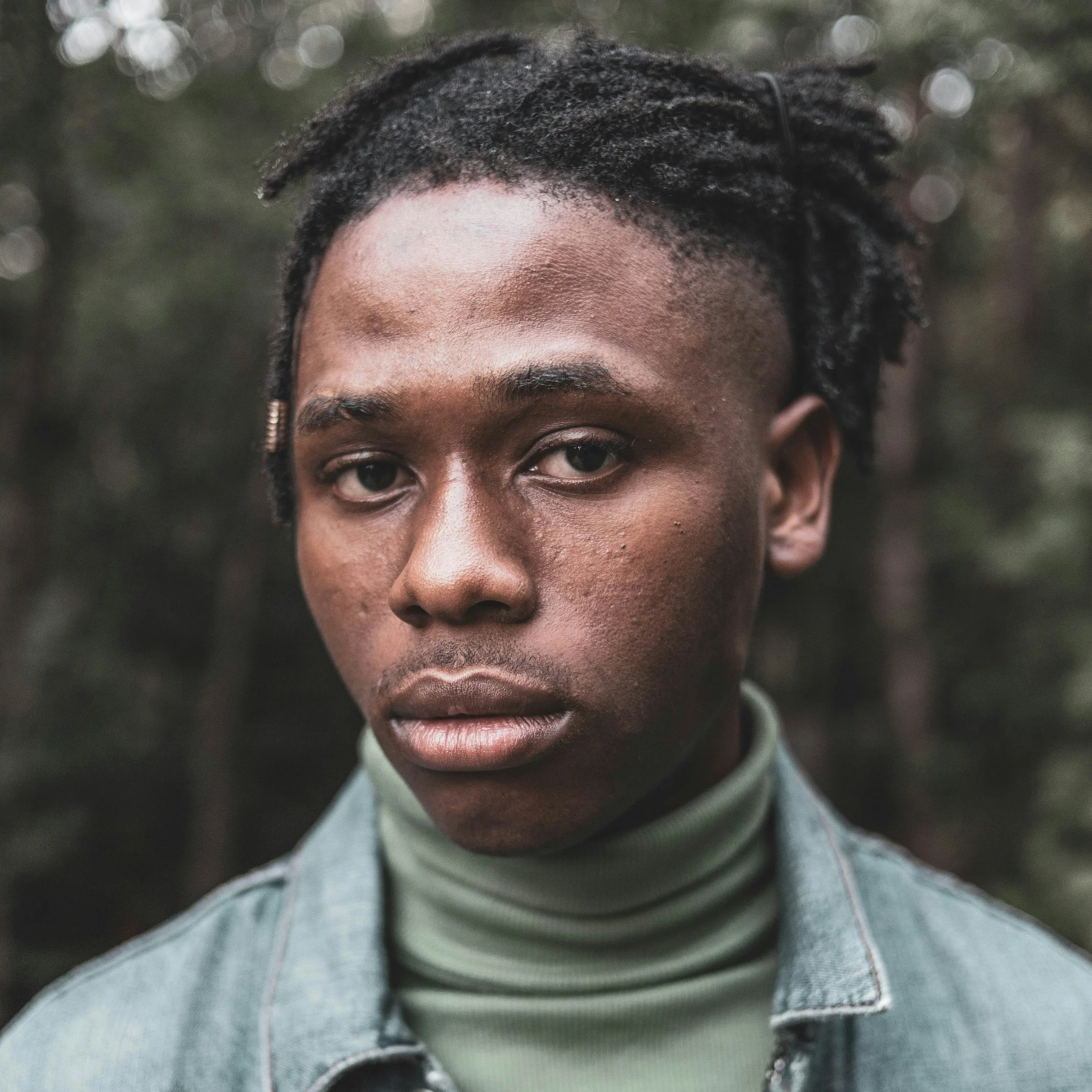 Young man stares at camera seriously