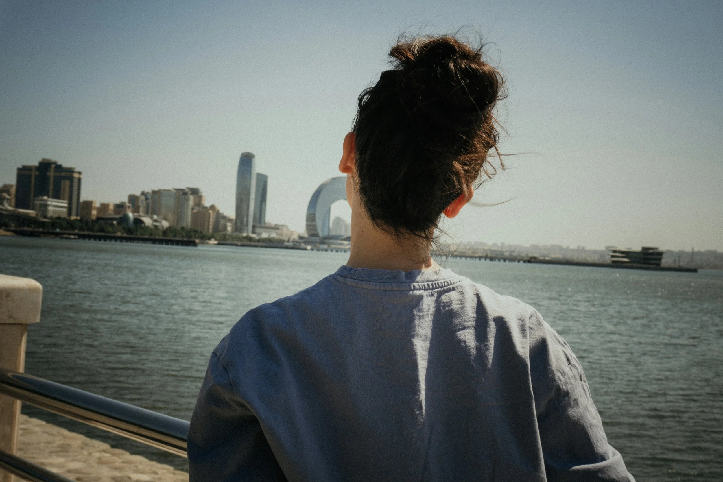 Girl looks out over the water