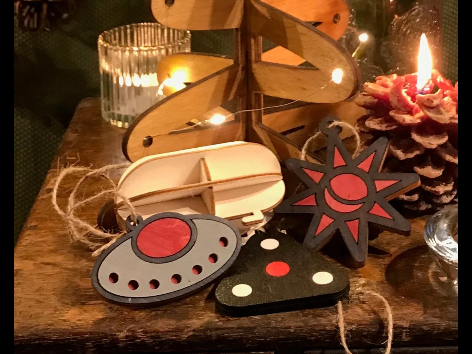 Photo of 4 traditional wooden Christmas Tree decorations, including a tic tac, saucer, triangle and orb