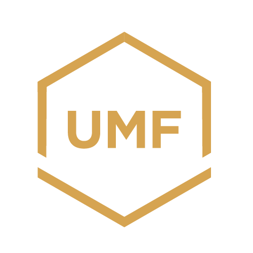 A black background with a gold hexagon outline and the letters "UMF" inside in gold.