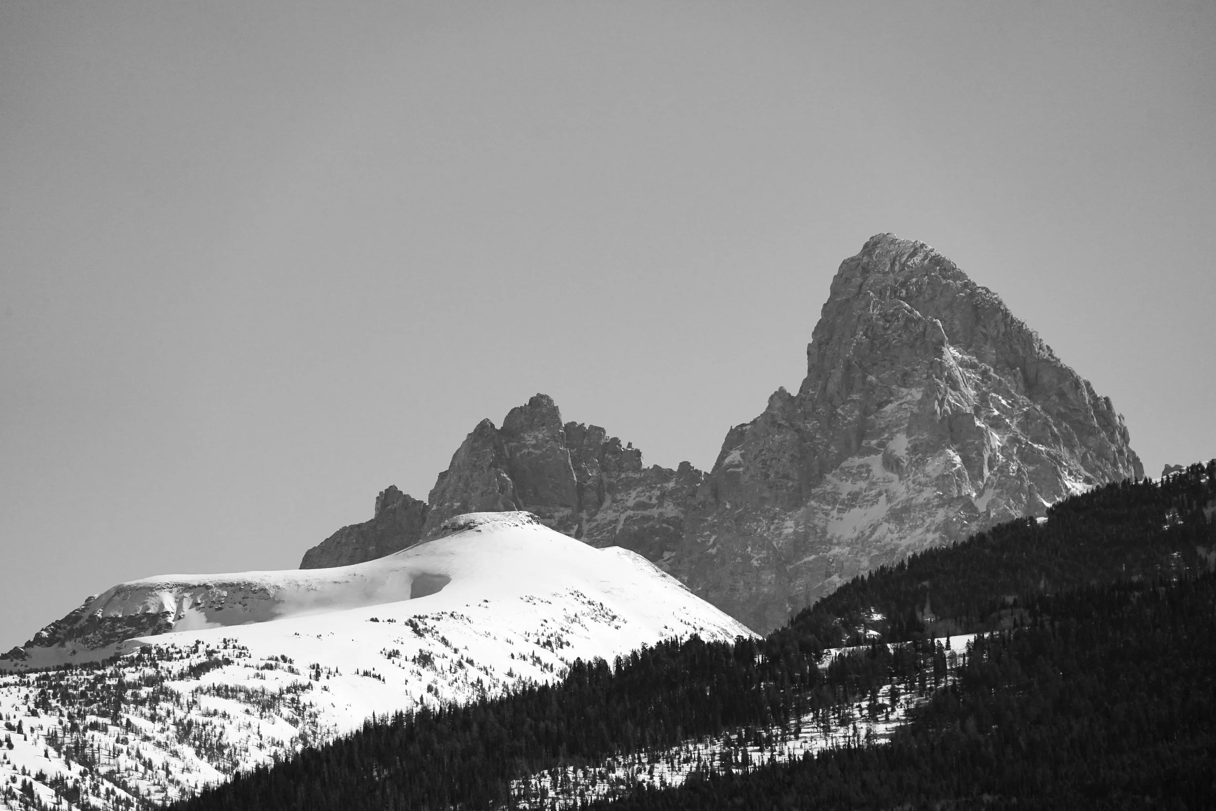 The Grand Teton peaking over the course
