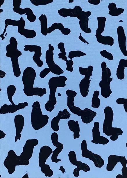 Abstract pattern of black shapes on a light blue background.