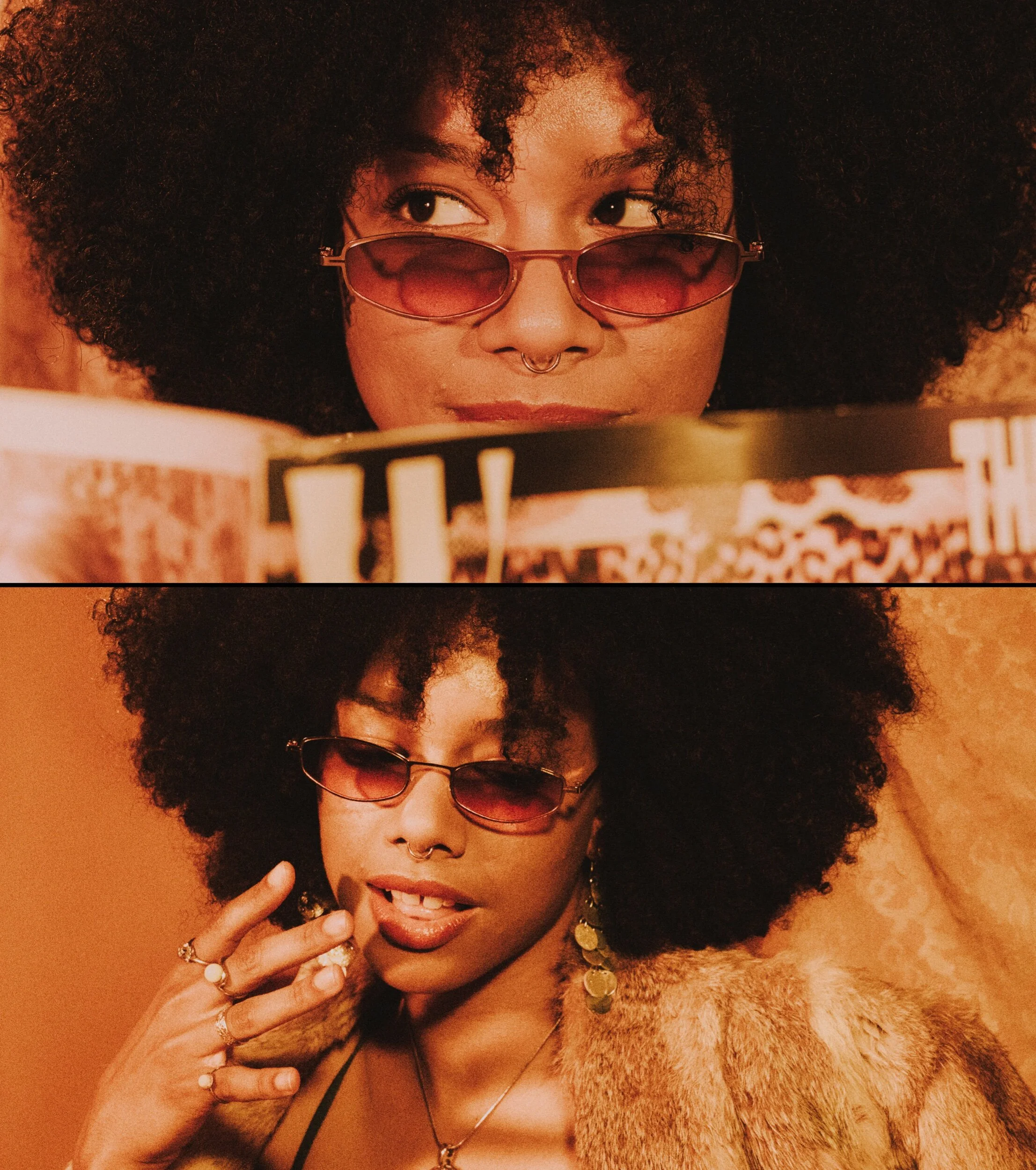 A woman with curly hair and light brown skin wearing pink-tinted sunglasses, gold jewelry, and a fur coat, touching her face with her left hand.