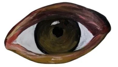 Close-up of a human eye with brown iris and surrounding skin.