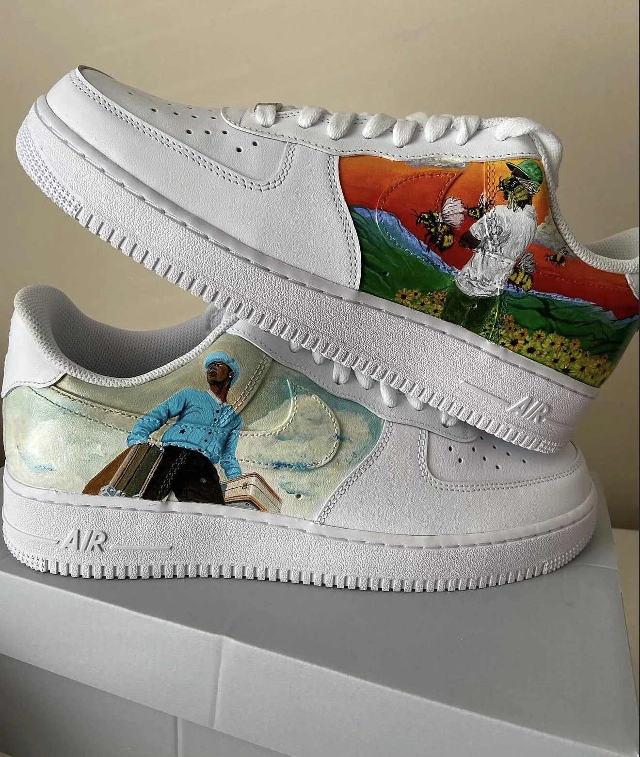 Custom-designed white sneakers with artistic painted illustrations on each shoe, featuring colorful backgrounds and characters.