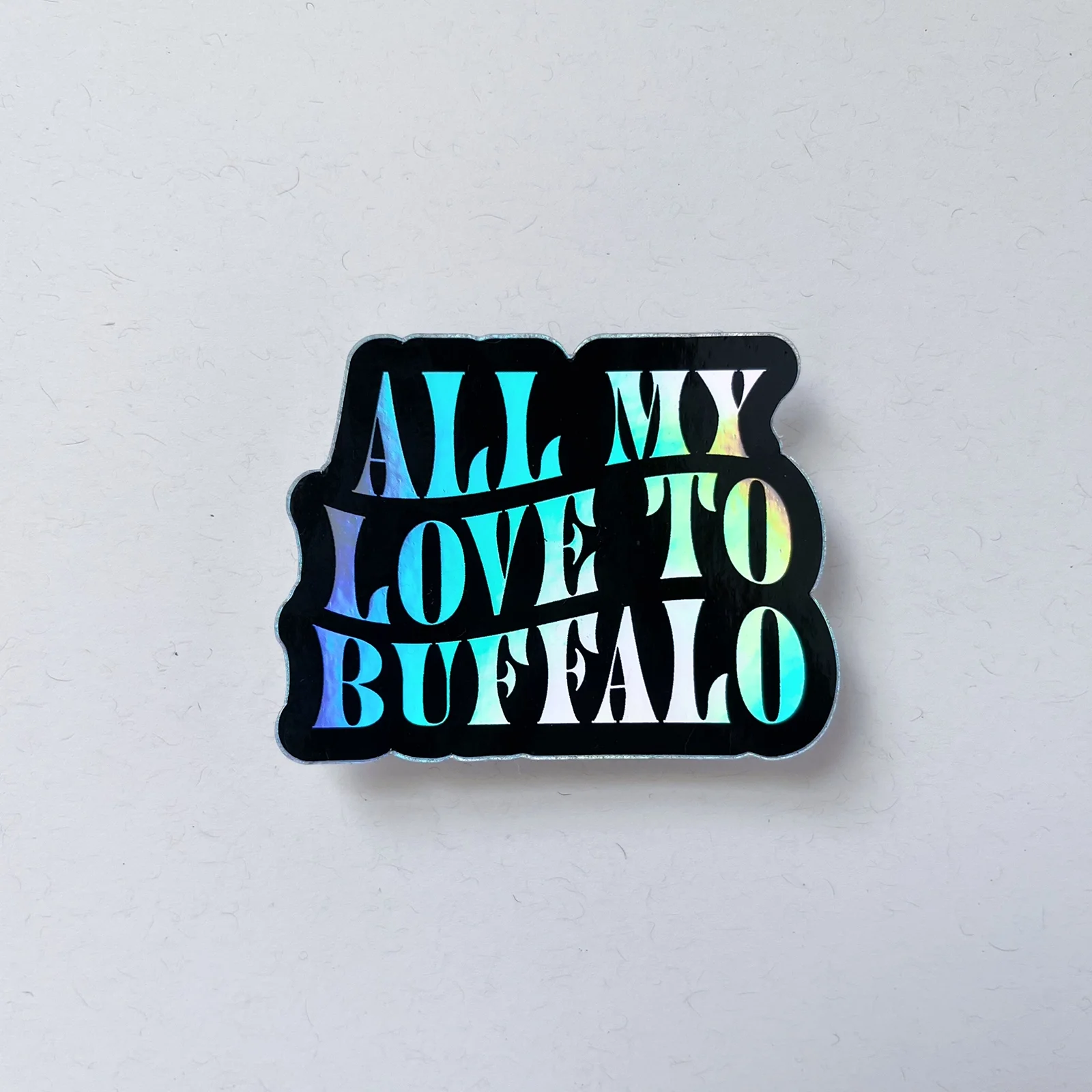 Holographic sticker with the text "All My Love To Buffalo" on a white background.