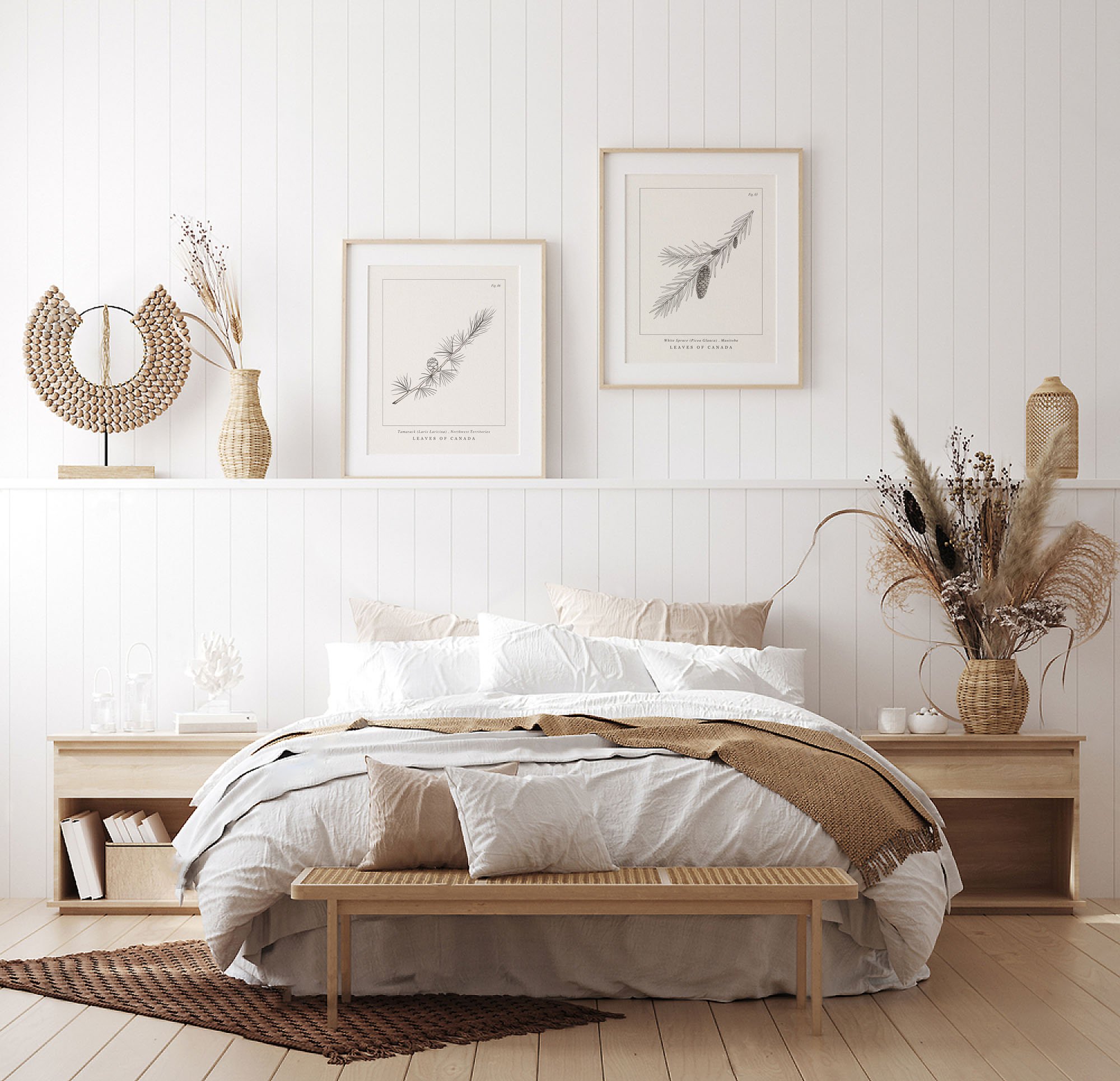 Light-coloured bedroom with two wooden framed botanical illustrations on the white wall