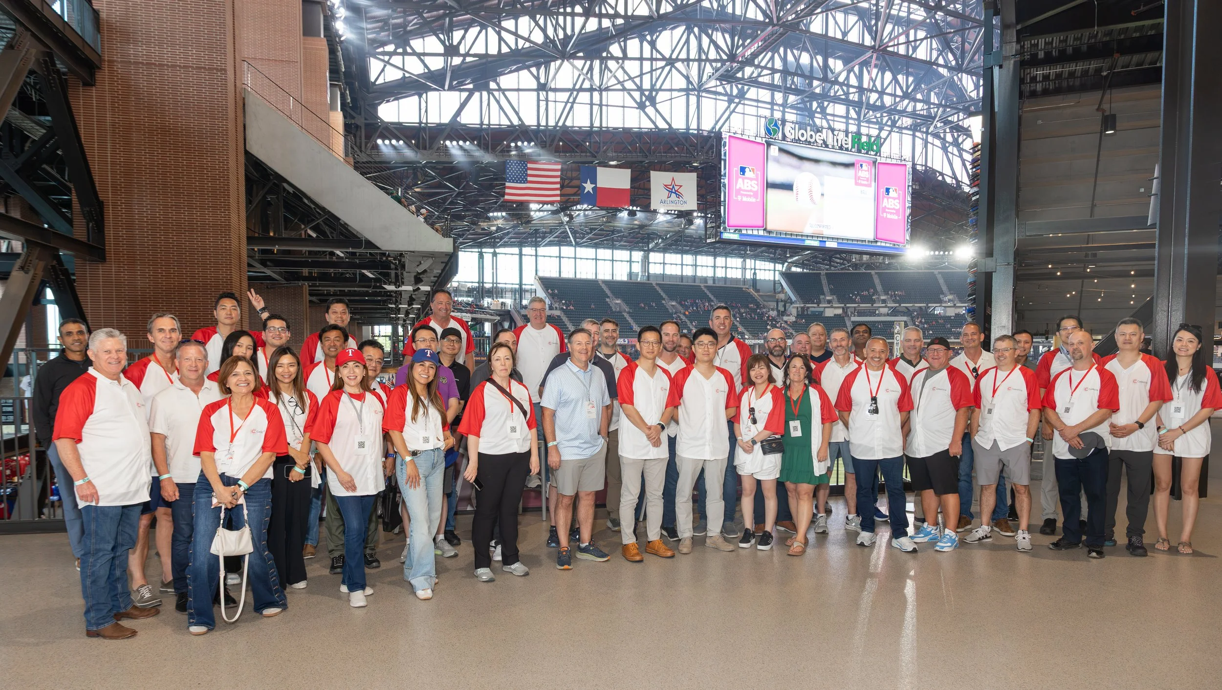 Large group posing inside Globe Life Field baseball stadium in Arlington, Texas