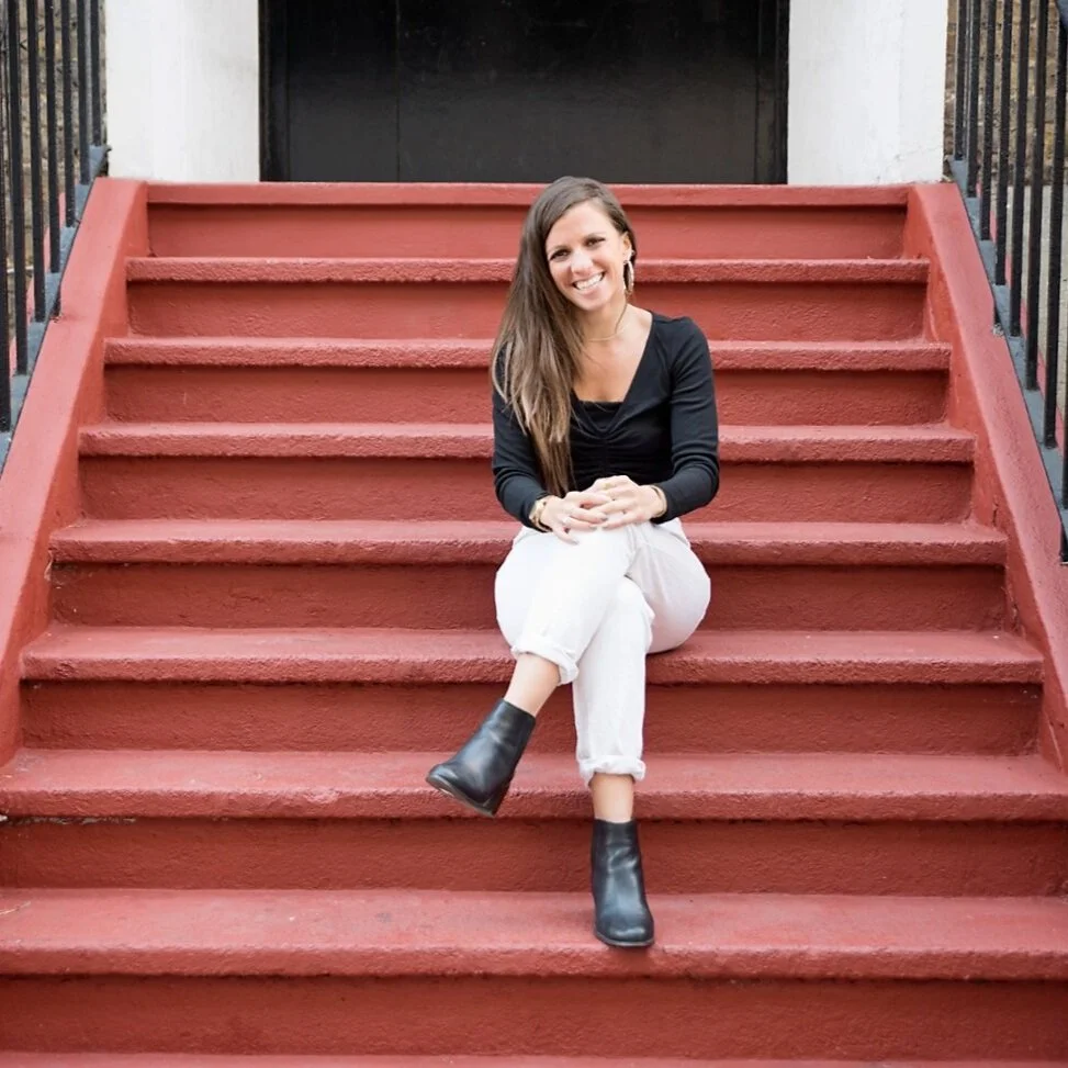 Sophie Harris, online pregnancy therapist sat on stairs