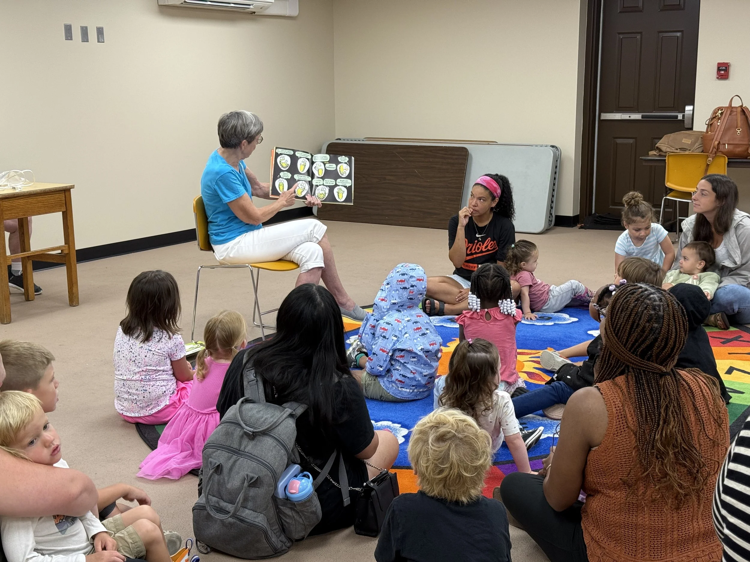 Group of children and parents listening to story time. 