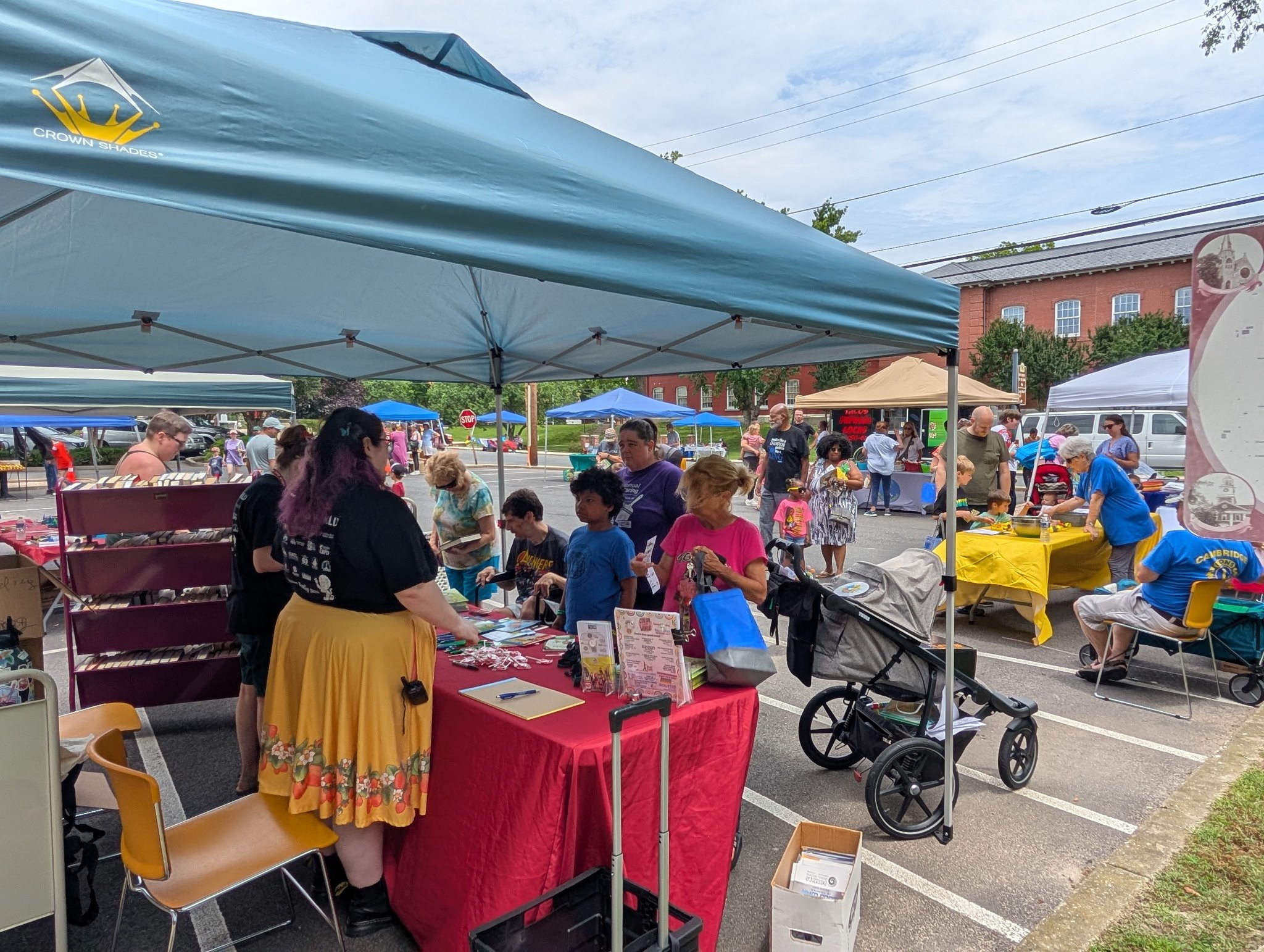 Children gathered around summer reading sign up table. 