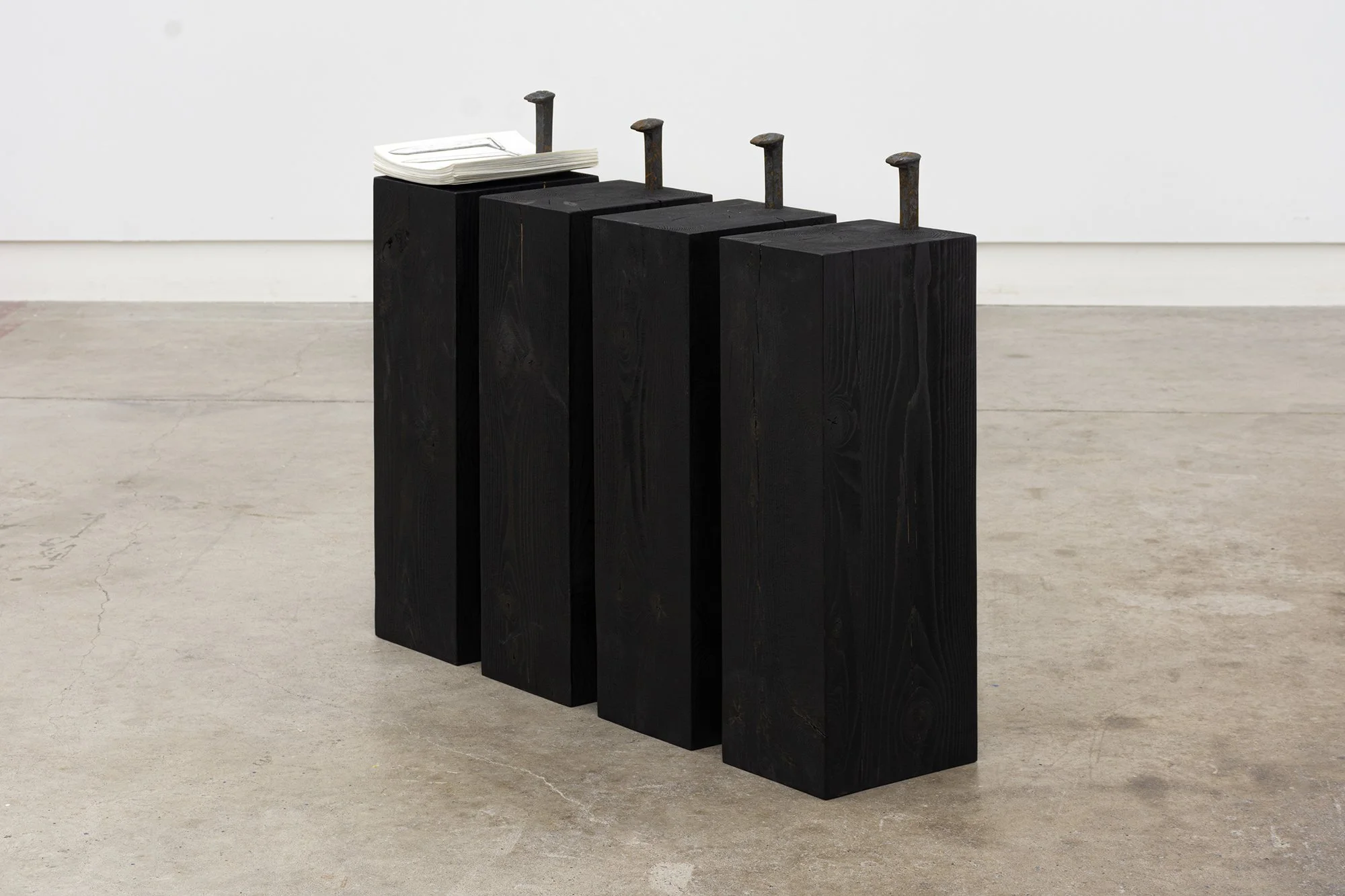 Melanie Colosimo, One Kilometre of Railroad in Four Parts (under construction), 2025. Graphite on paper, found railroad spikes, Hemlock base. Approx. 28 x 7 x 9 inches. 