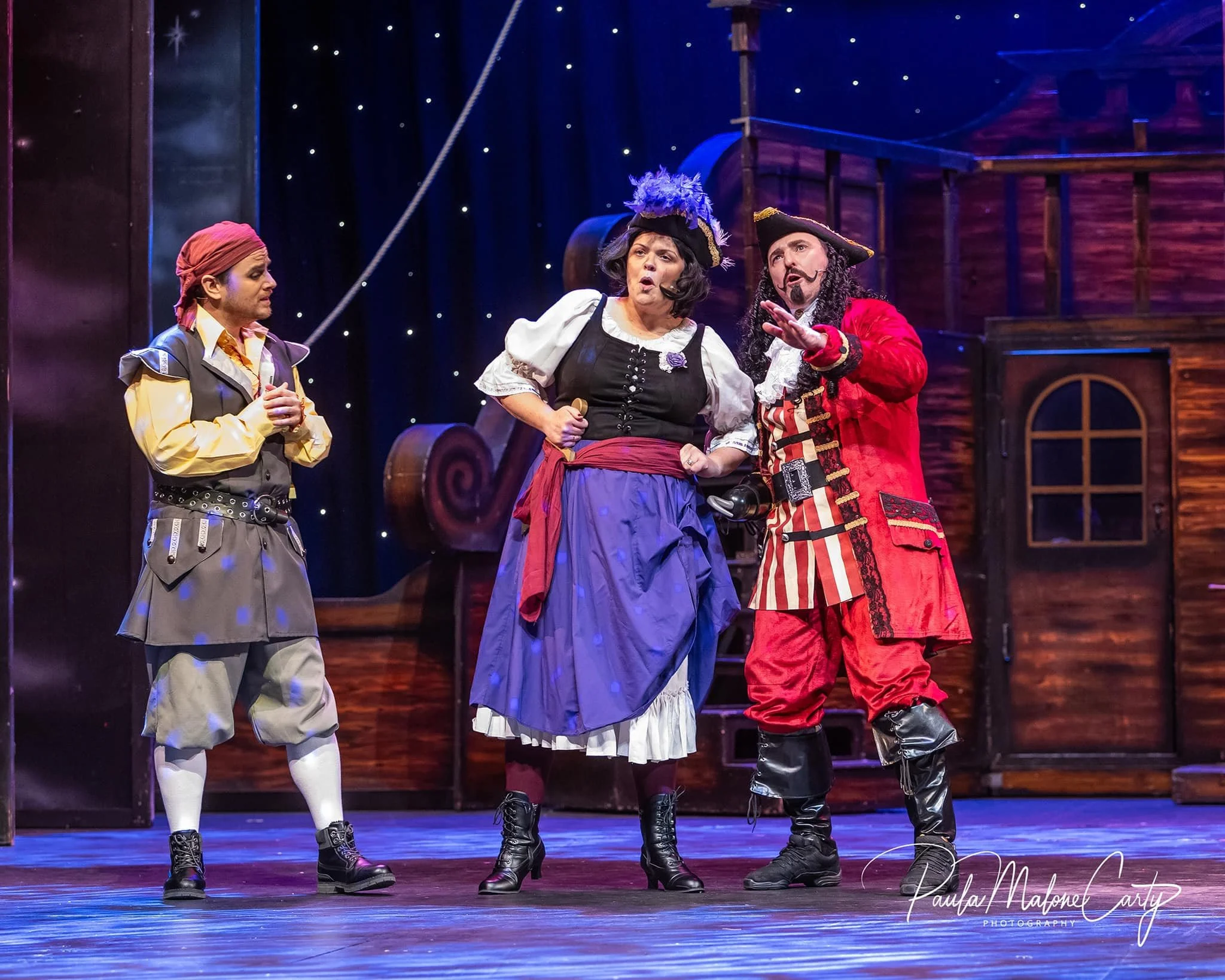 Michael McKenny as the Italian pirate Cecco, alongside Eithe Hodnett and Neal O'Leary, both reprising their roles of Cookson and Captain Hook from 2012