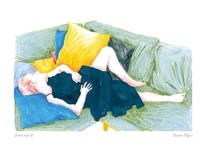A young girl is having a sweet nap on a colored sofa.